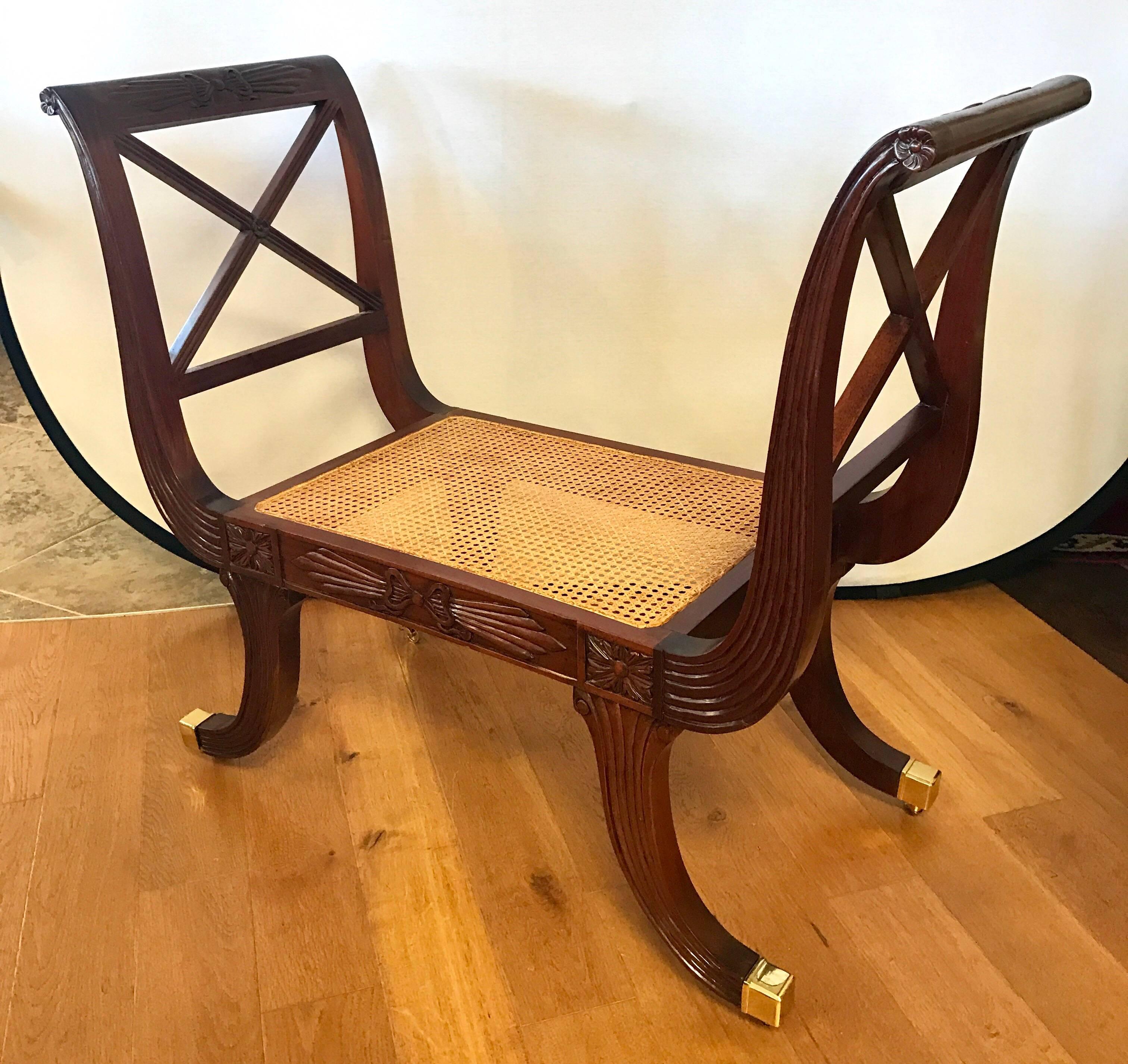 Stunning and rare set of neoclassical carved mahogany window benches with cane seats and brass castors. Measures: Seat height is 16.5 inches.
Gorgeous ribbon carvings throughout.