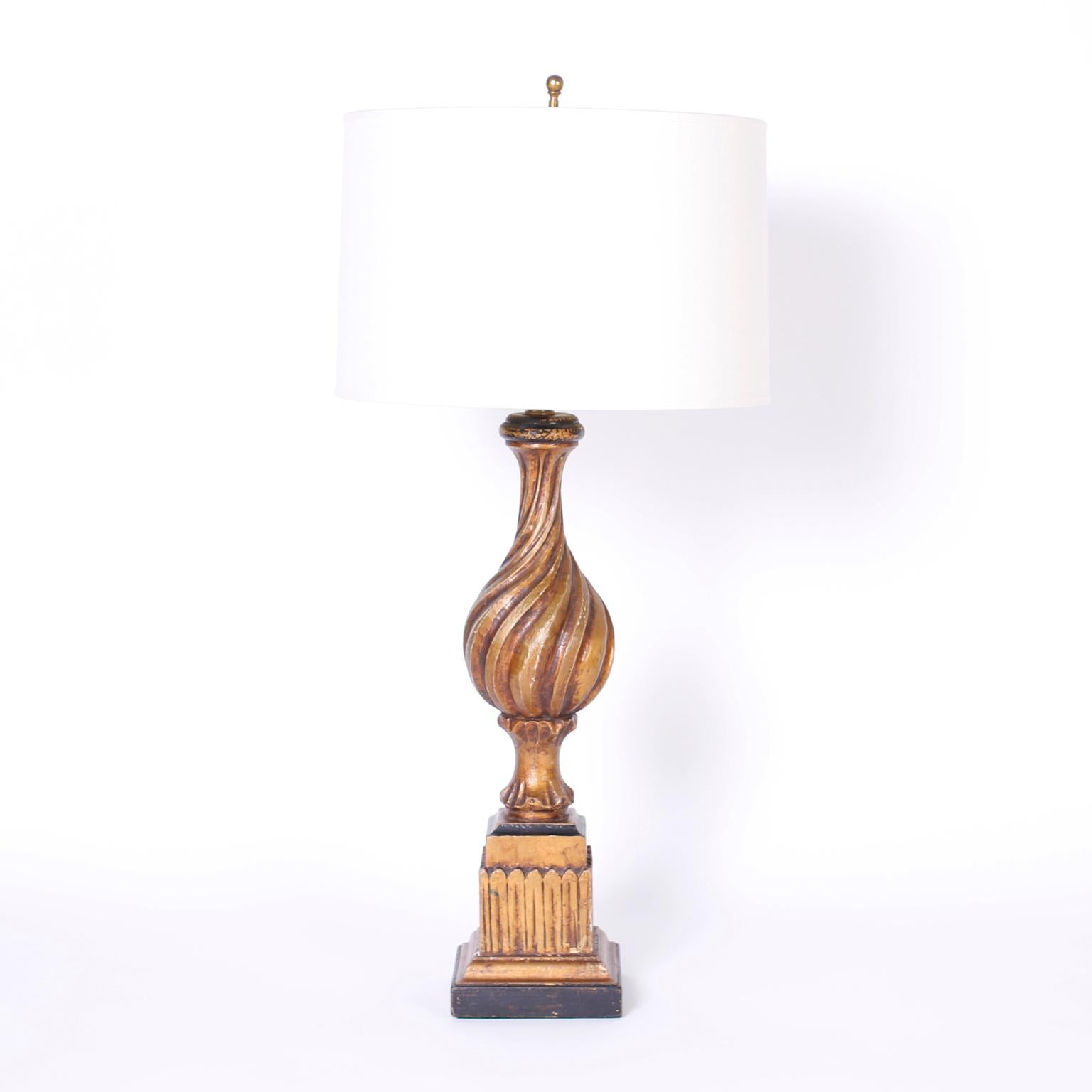 Antique pair of Italian carved wood table lamps with Classic form; turned, carved, gessoed, and gilded then aged to perfection.