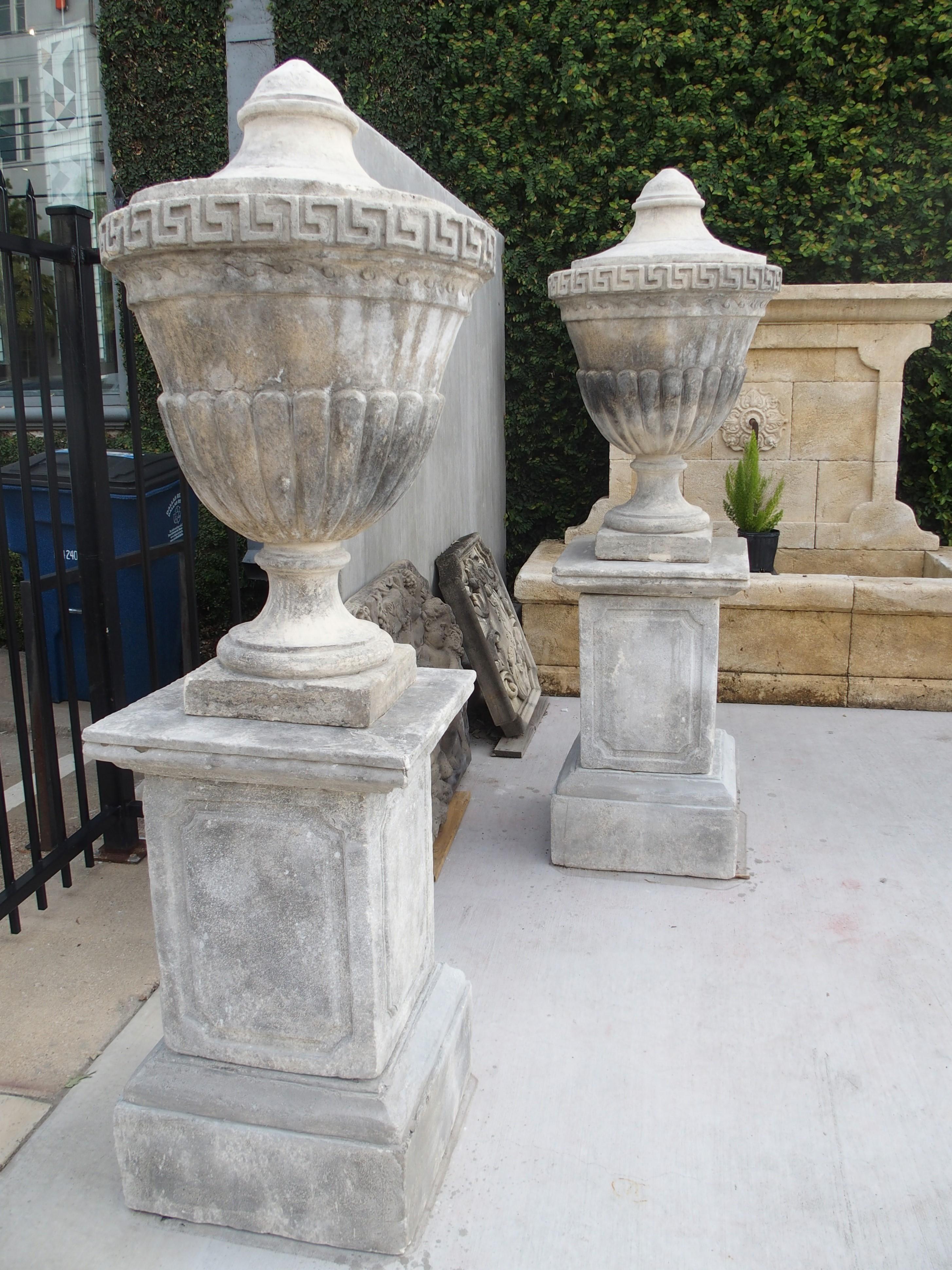 Cast Stone Pair of Neoclassical Composition Limestone Urns on Pedestals, Southern Italy