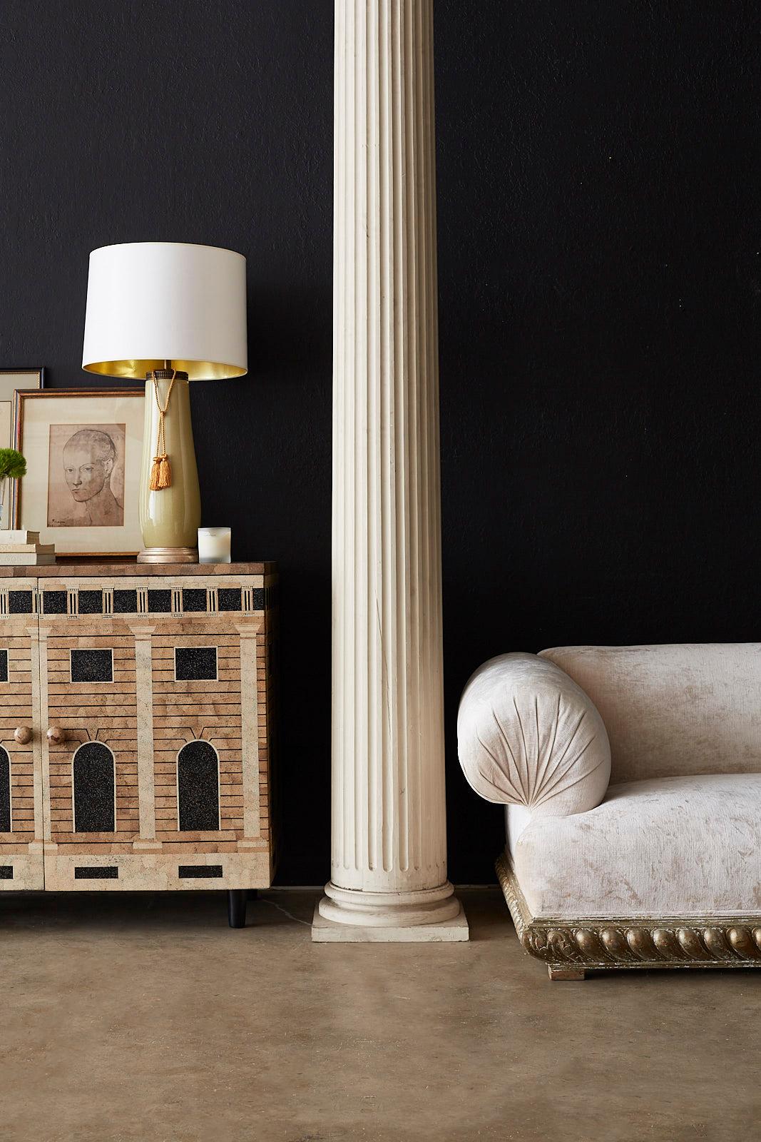 Elegant pair of fluted carved wood columns made in the Neoclassical taste. Featuring tall, fluted forms that taper from 14.5 inches to 11.5 inches wide. Mounted on square bases that accentuate the round pillars. Vintage lacquer finish shows signs of