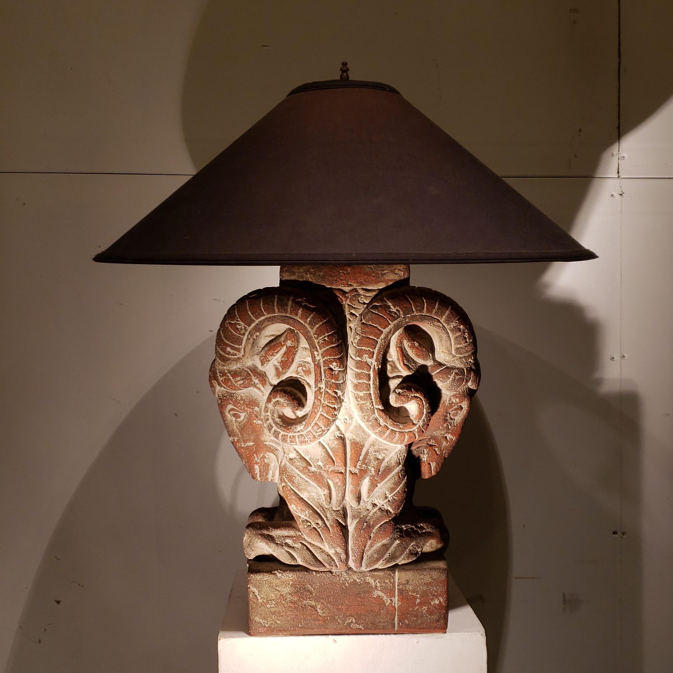 A very strong pair of rams head lamps in plaster and terracotta. Retains the original shades but they should be replaced.
