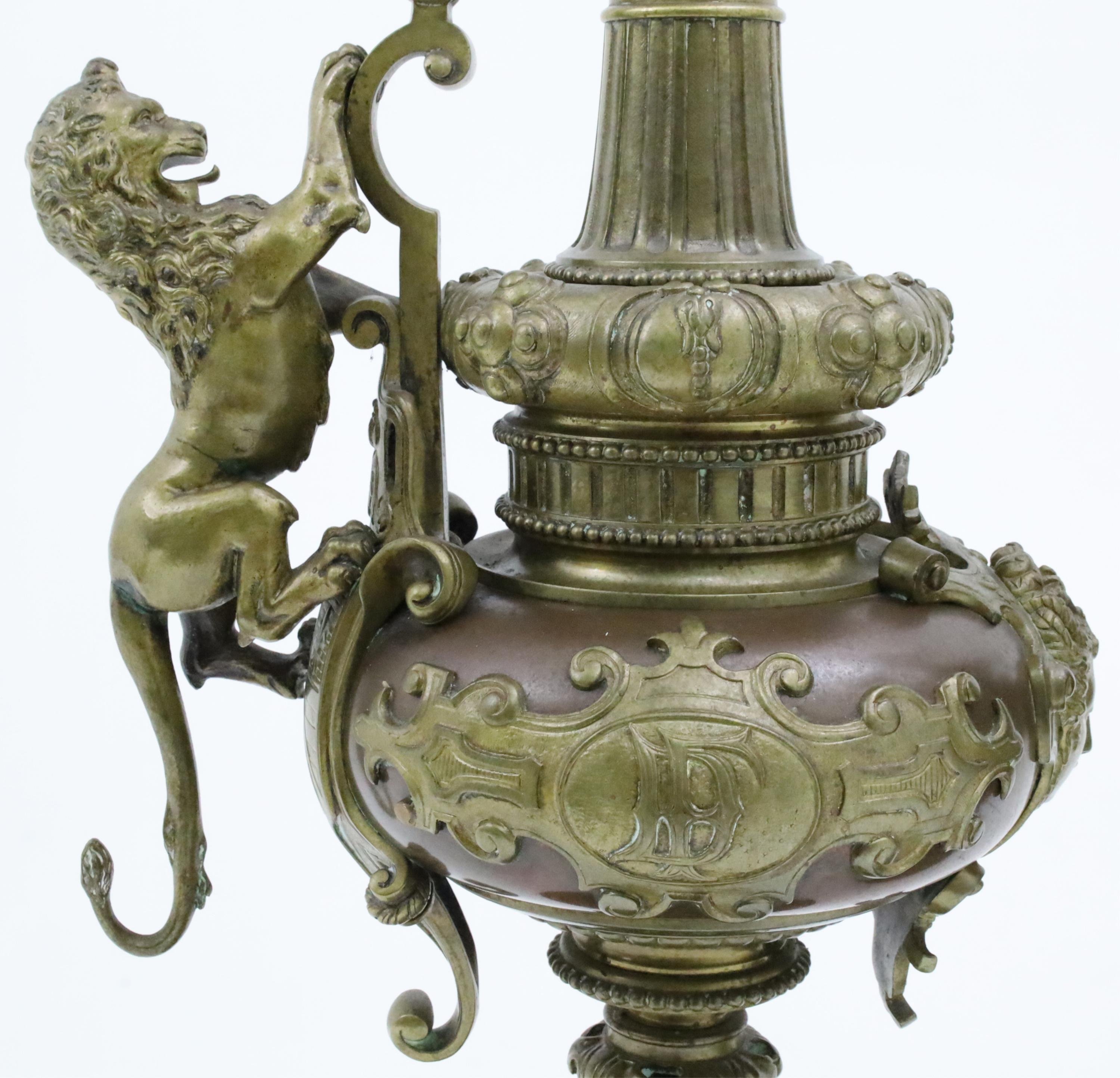 Large pair of Neoclassical French bronze ewers, ornately cast with cherub and lion surmount handles, 19th century