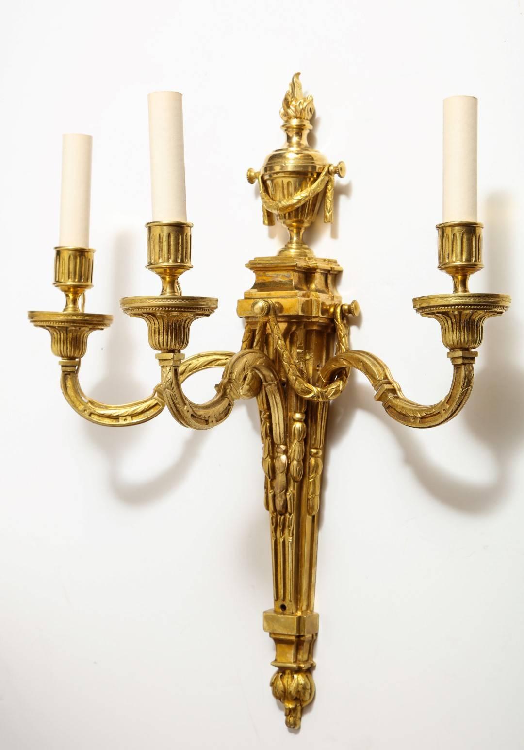 A pair of neoclassical gilt bronze sconces.