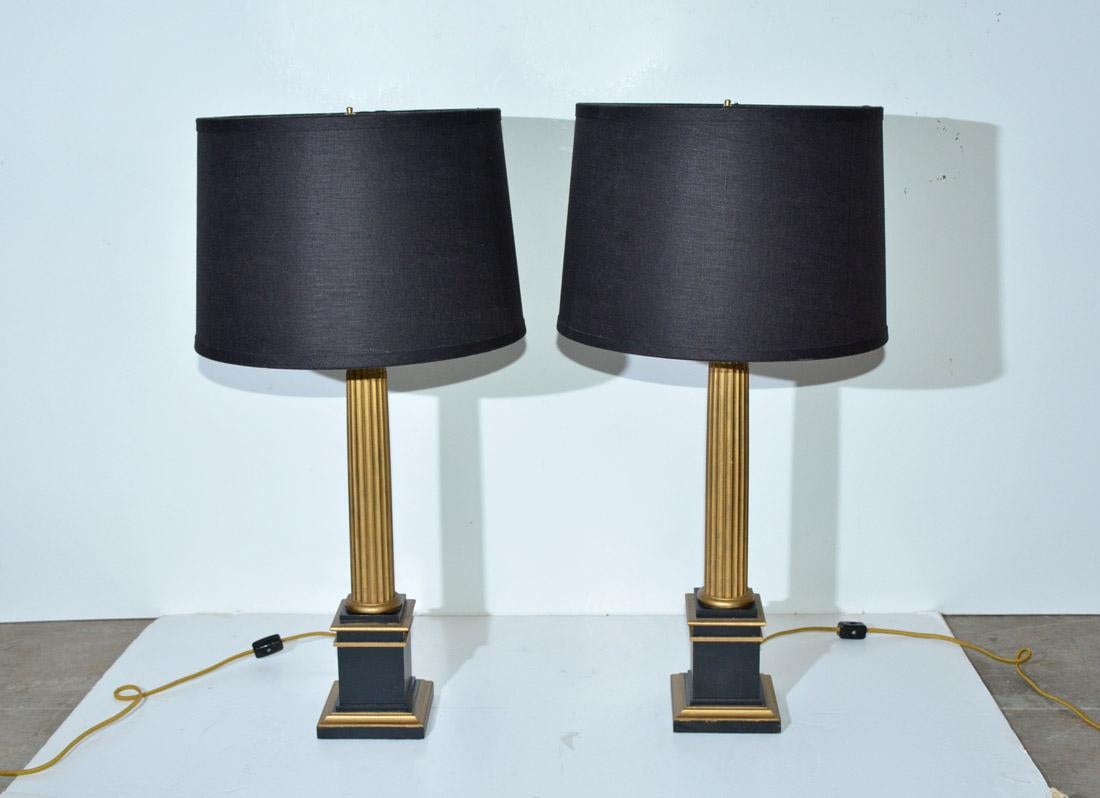 The vintage classical lamps have gold fluted columns sitting on black square pedestals trimmed in gold. The bottoms have felt padding. The single light lamps are electrified for US use and have cord switches. 

 The black linen shades are lined