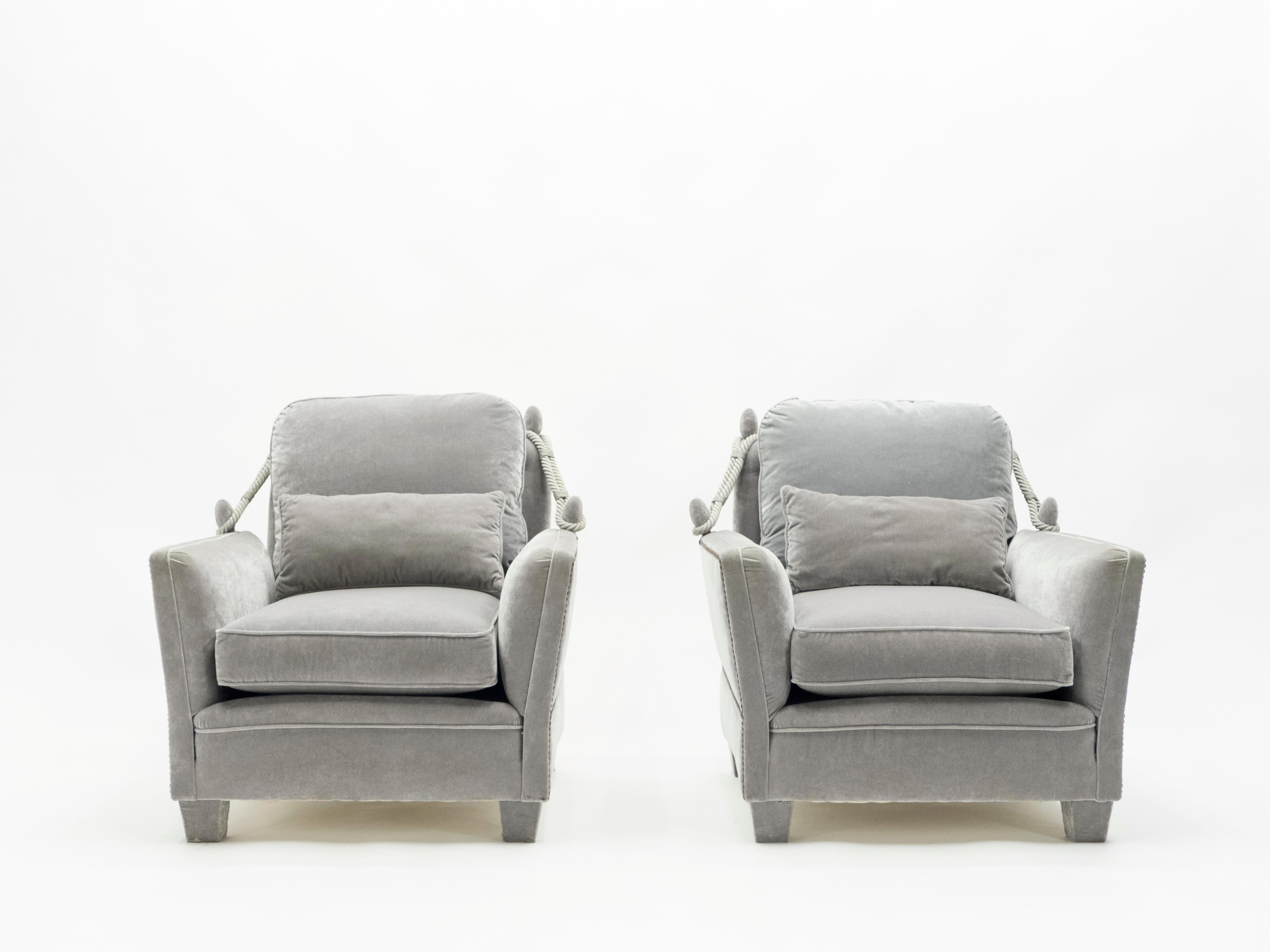 These chic, monochromatic French 1970s Maison Jansen armchairs feature their original, beautiful neoclassical structure, newly reupholstered in soft grey velvet Nobilis Quai de Seine. Passementerie details at either side give the pair an