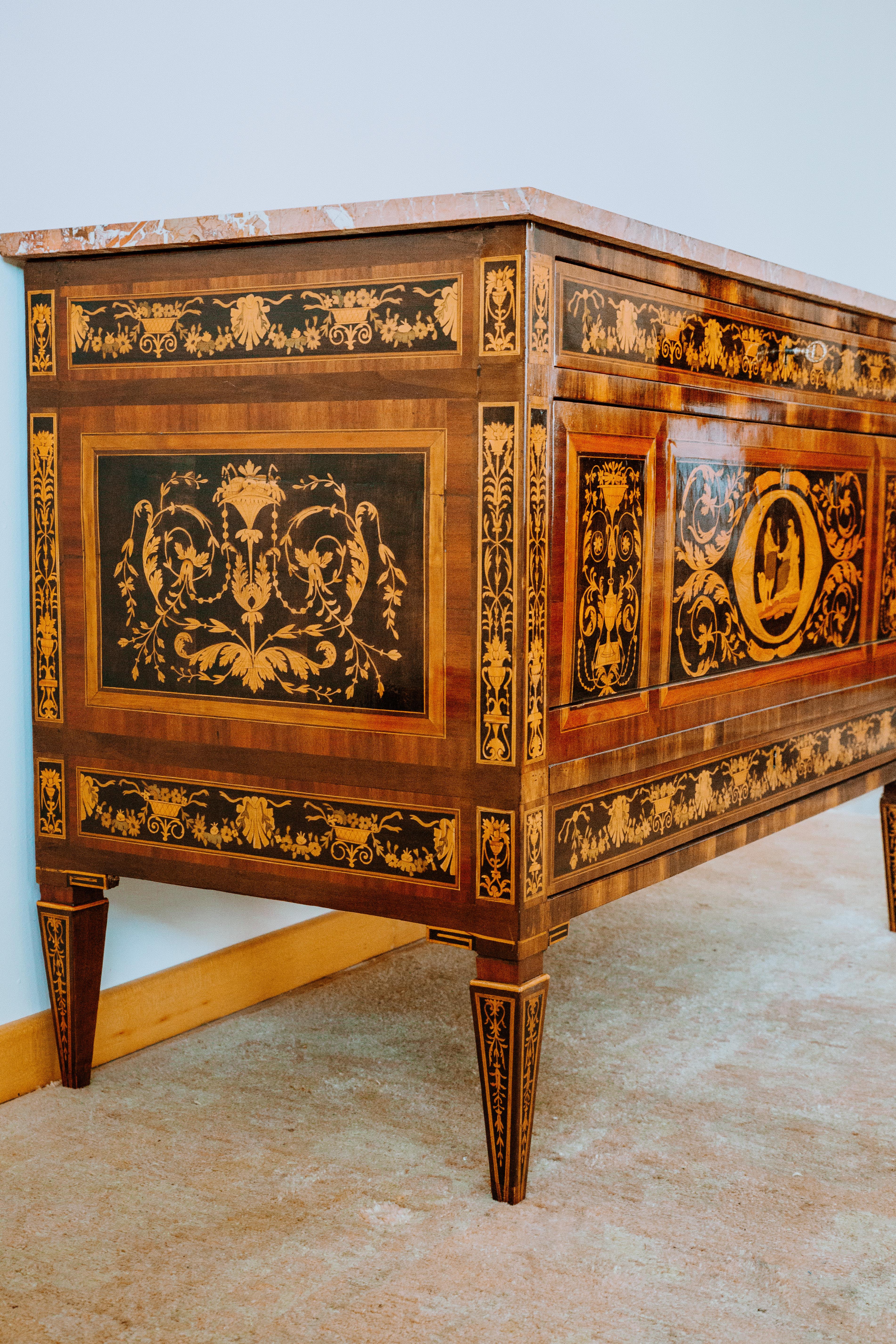 This exceptional pair of Italian neoclassical 18th century dressers in wood richly inlaid on the front, sides and 4 truncated pyramid legs are top-quality example of Italian 18th century cabinetmaking. The pair of commodes are originals from the