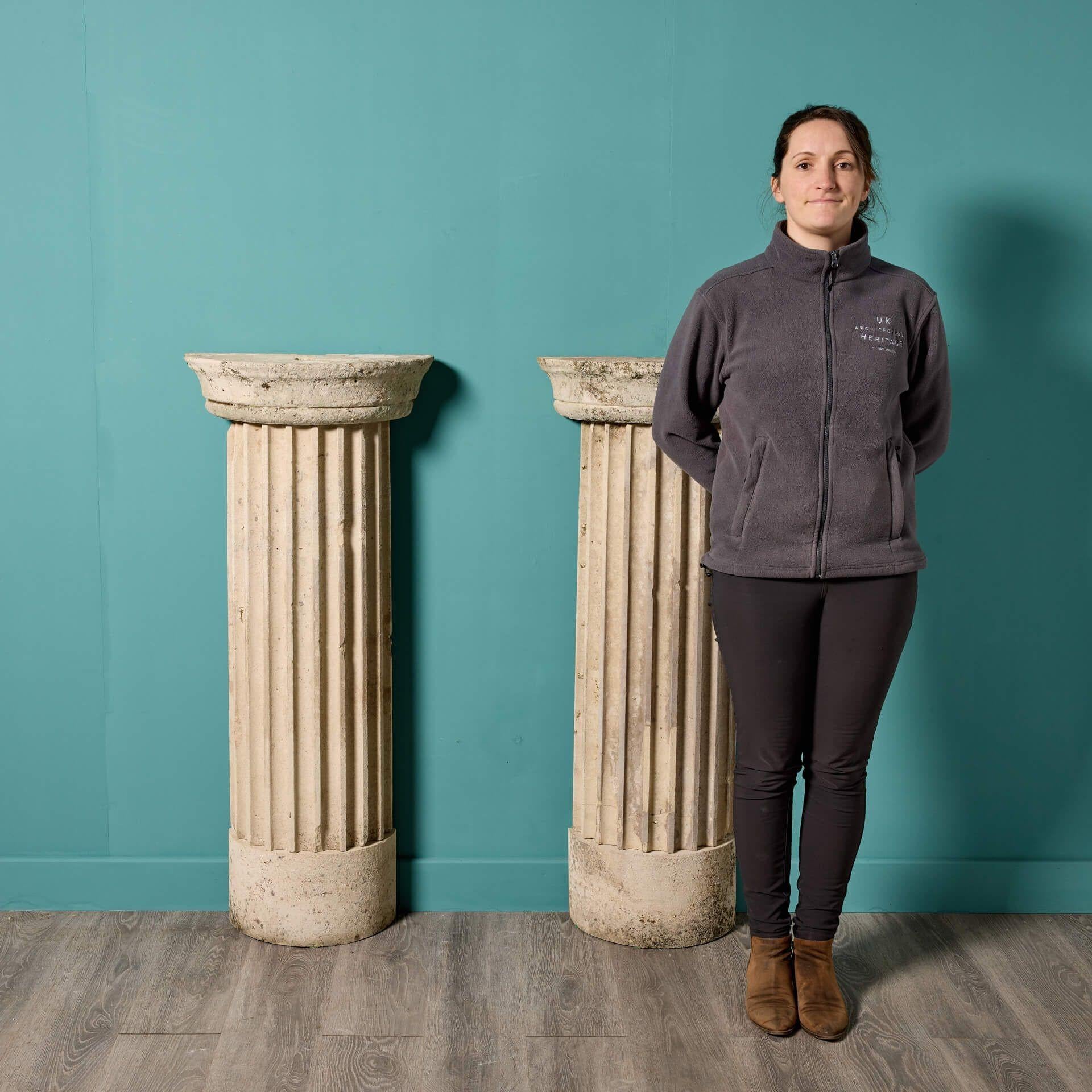 An impressive pair of English neoclassical style Portland limestone column pedestals dating to circa 1800. Suitable for use as display plinths or simply architectural features, these 220-year-old late Georgian stone columns are evocative of the