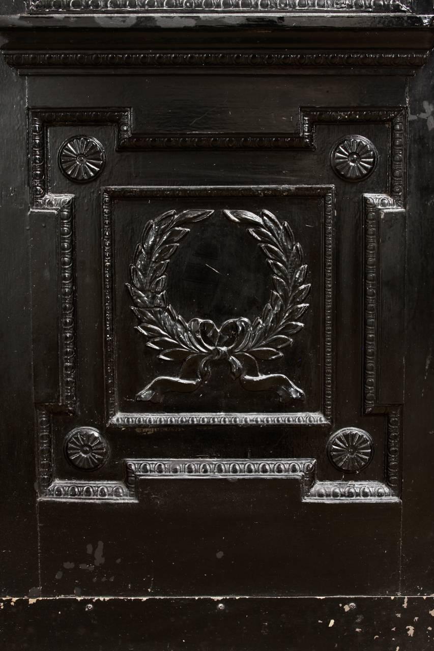 Remarkable pair of French Louis XVI style lacquered pub, cafe, or bistro doors. Hand-carved in the neoclassical taste featuring laurel wreaths and ribbon swag relief decorations. Each door has a glass window with a small 2