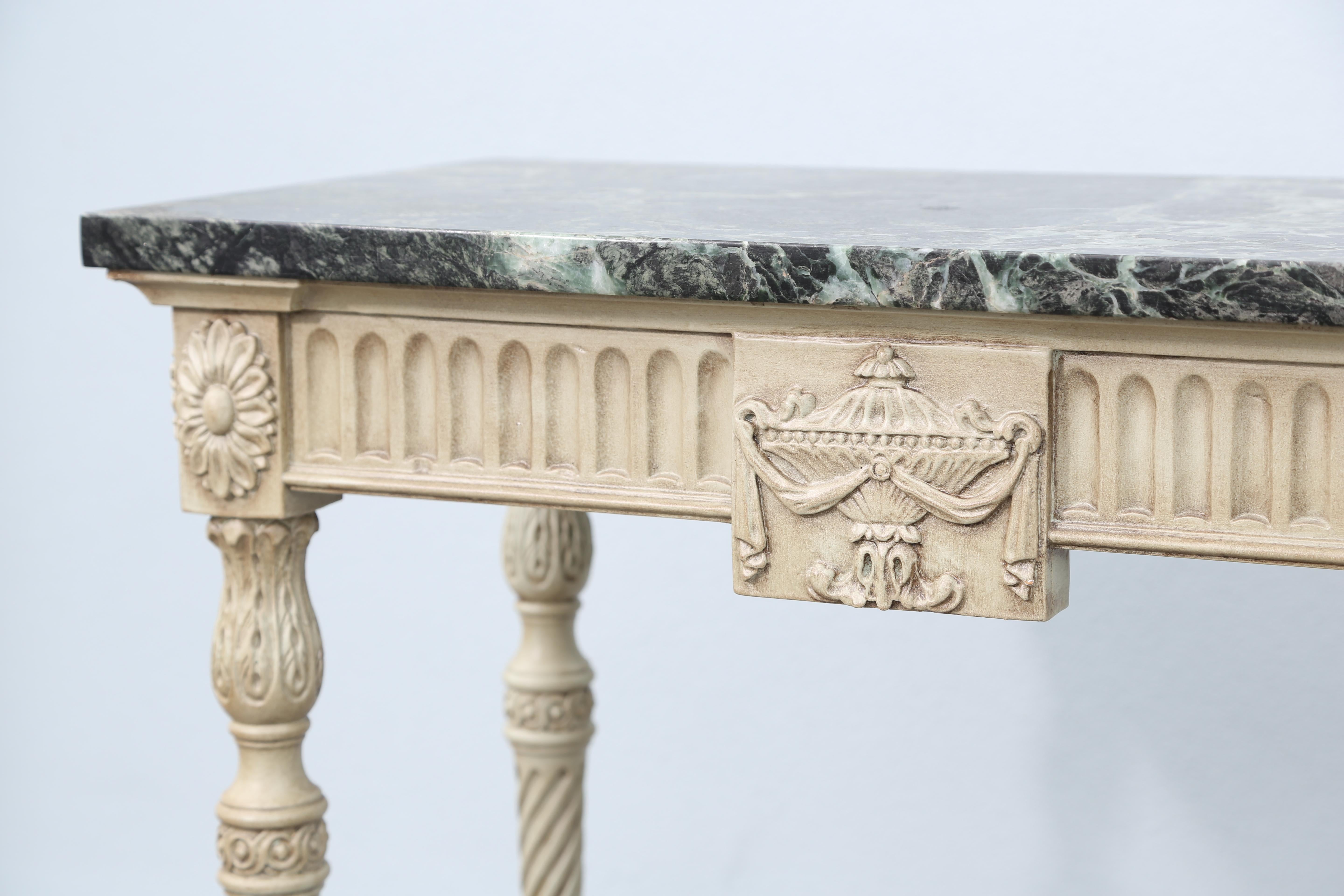 Pair of neoclassical carved and painted wood consoles with green veined marble tops.