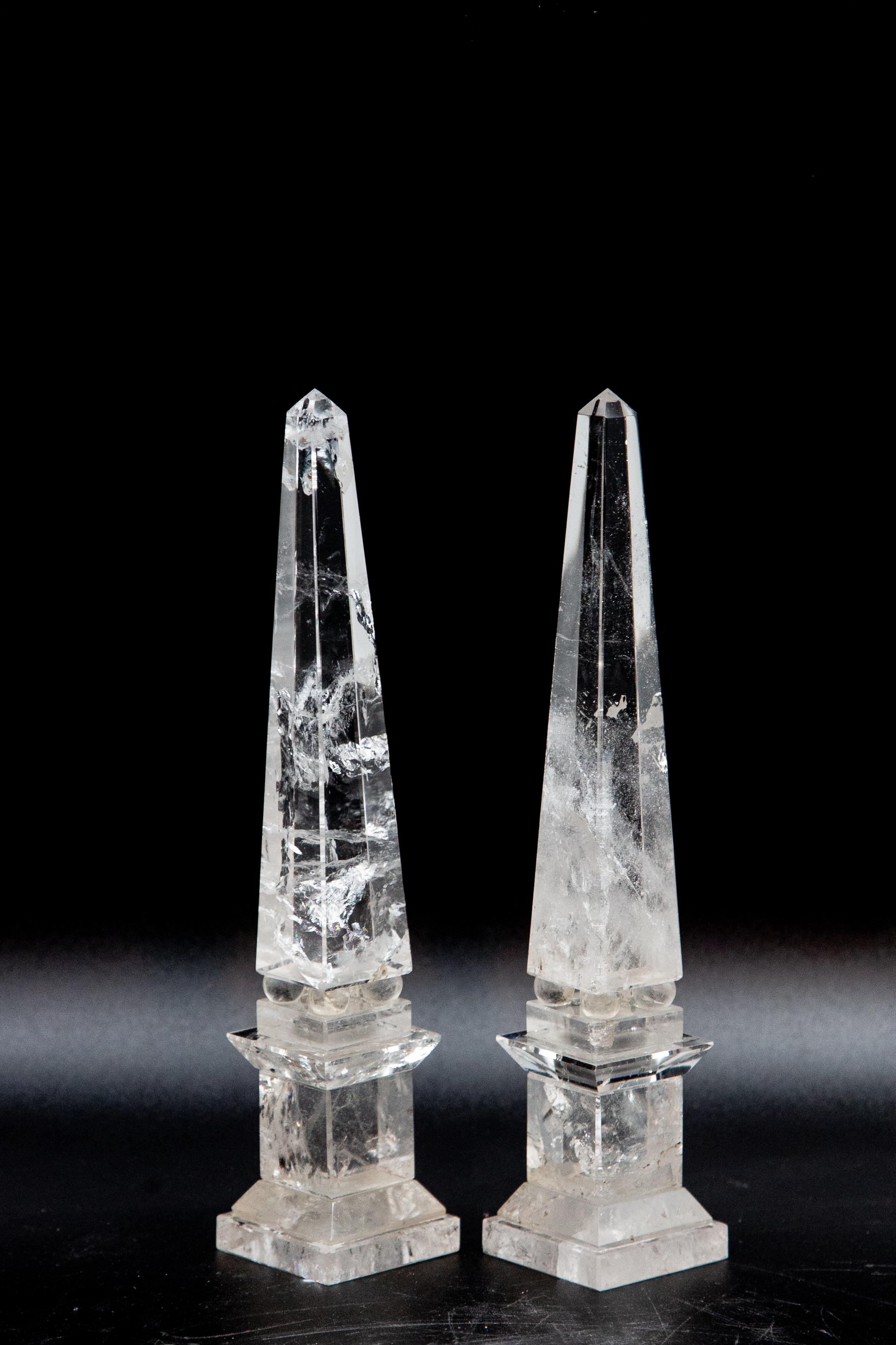 Pair of neoclassical rock crystal obelisks. Pair of hand-cut rock crystal obelisks on square plinth bases. Handmade in Madagascar.

Since antiquity, varieties of quartz have been historically used in the making of jewelry and hardstone carvings,