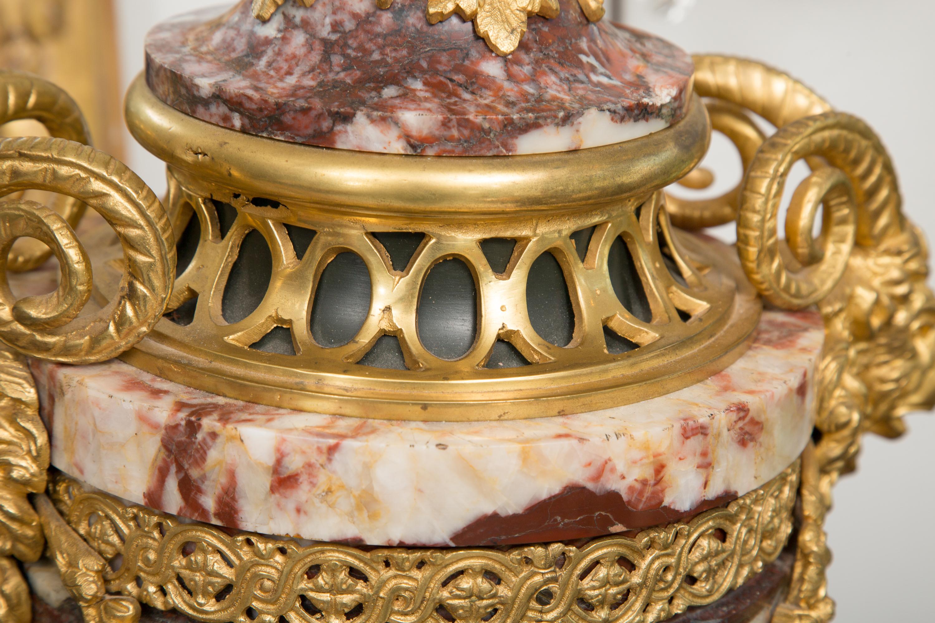 Polished Pair of Neoclassical Rouge Marble Urns with Gilt Bronze Mounts