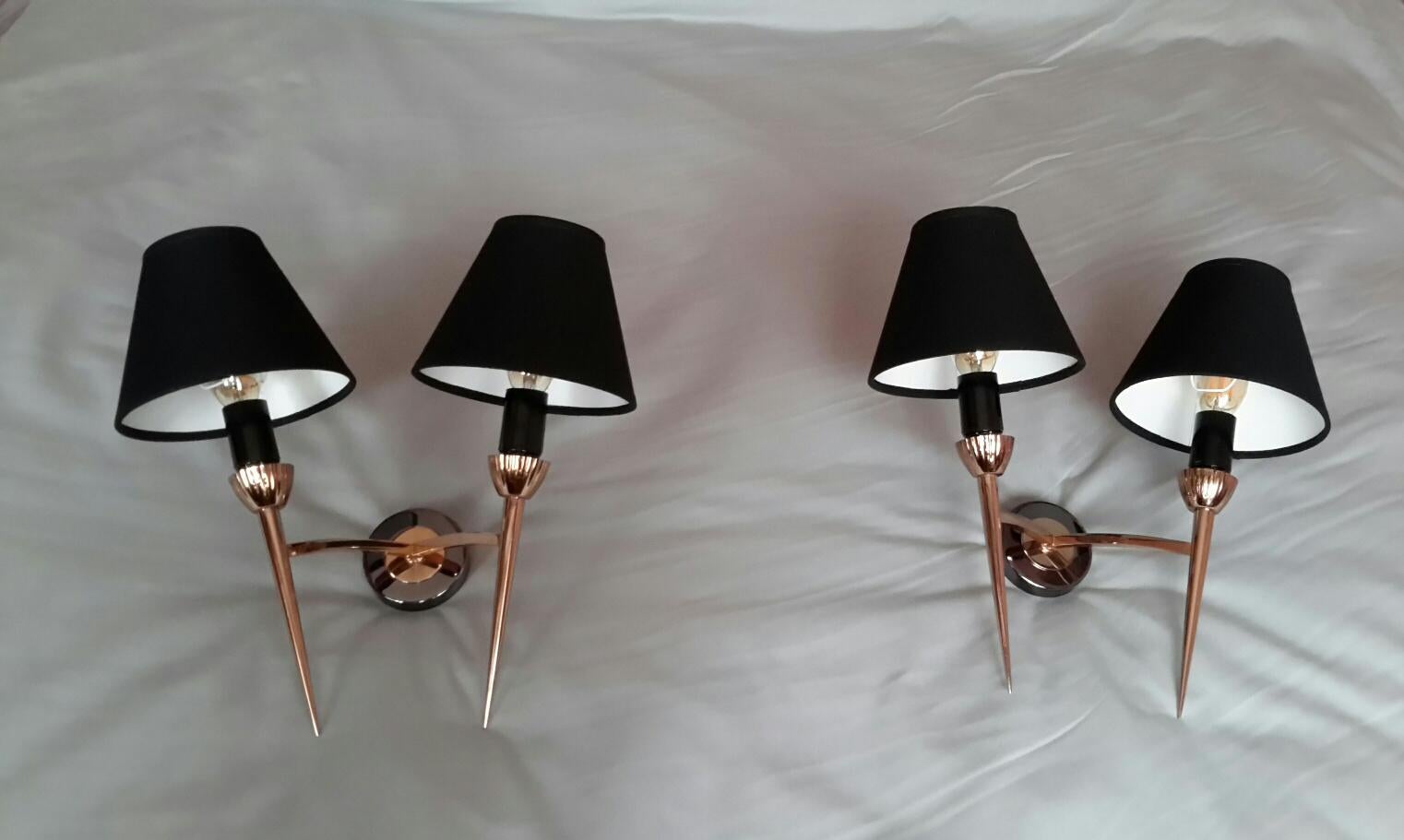 Beautiful pair of neoclassical 2 arms sconces in brass and metal gun patina from the 1950s by french Maison Lunel.
The pair is in an excellent condition. 
The electric part has been renewed (max 40 watts each bulb) and fit the US Standards. The
