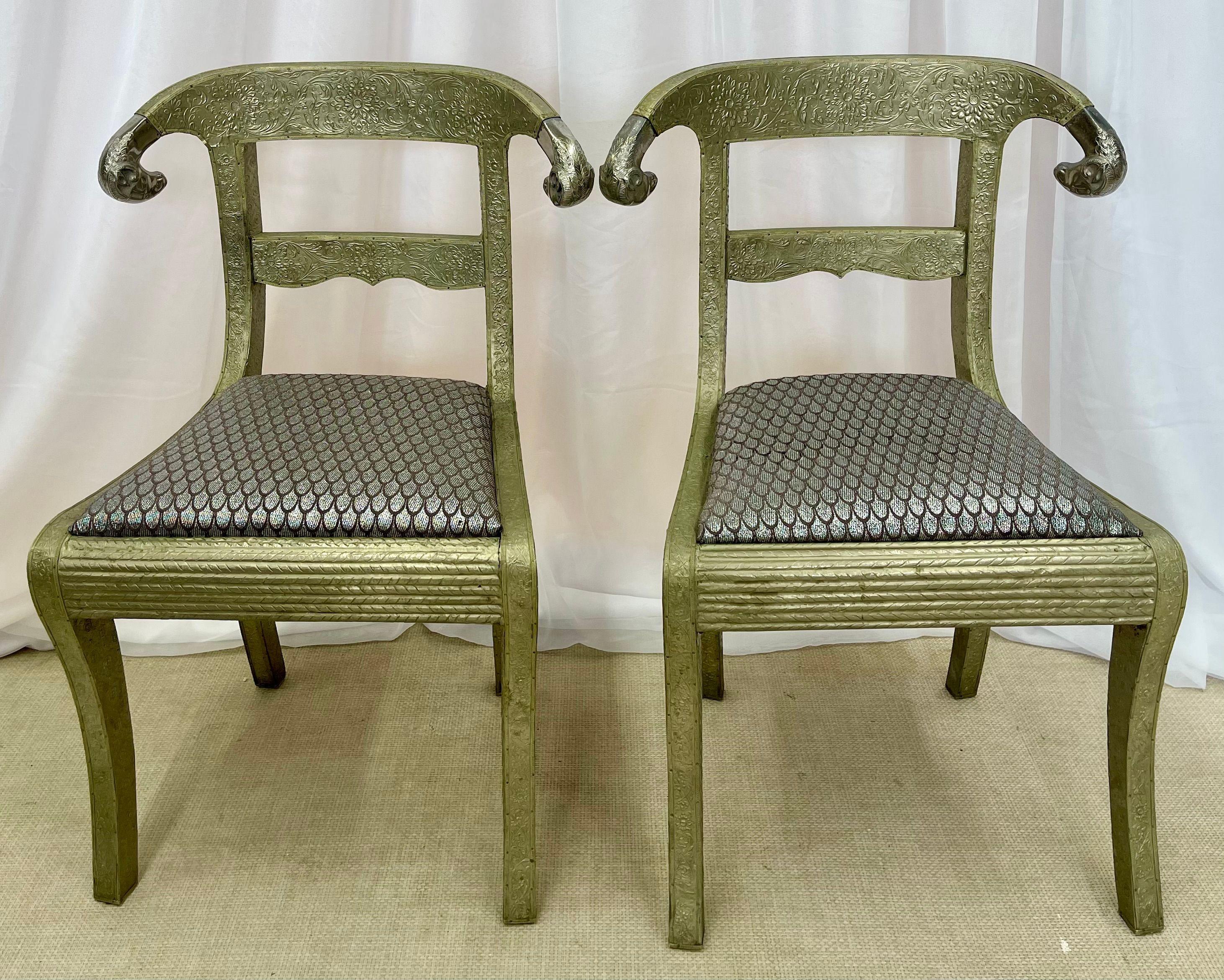 Pair of Gustavian or Neoclassical side chairs can be used in any room. Each having fully metal wrapped frames with Finely carved rams heads on the back rests. The finely wrapped metal frames with rose, vine and leaf design tacked securely upon the