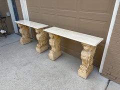 Pair of Neoclassical Stone Console Tables with Winged Mythological Stone Bases