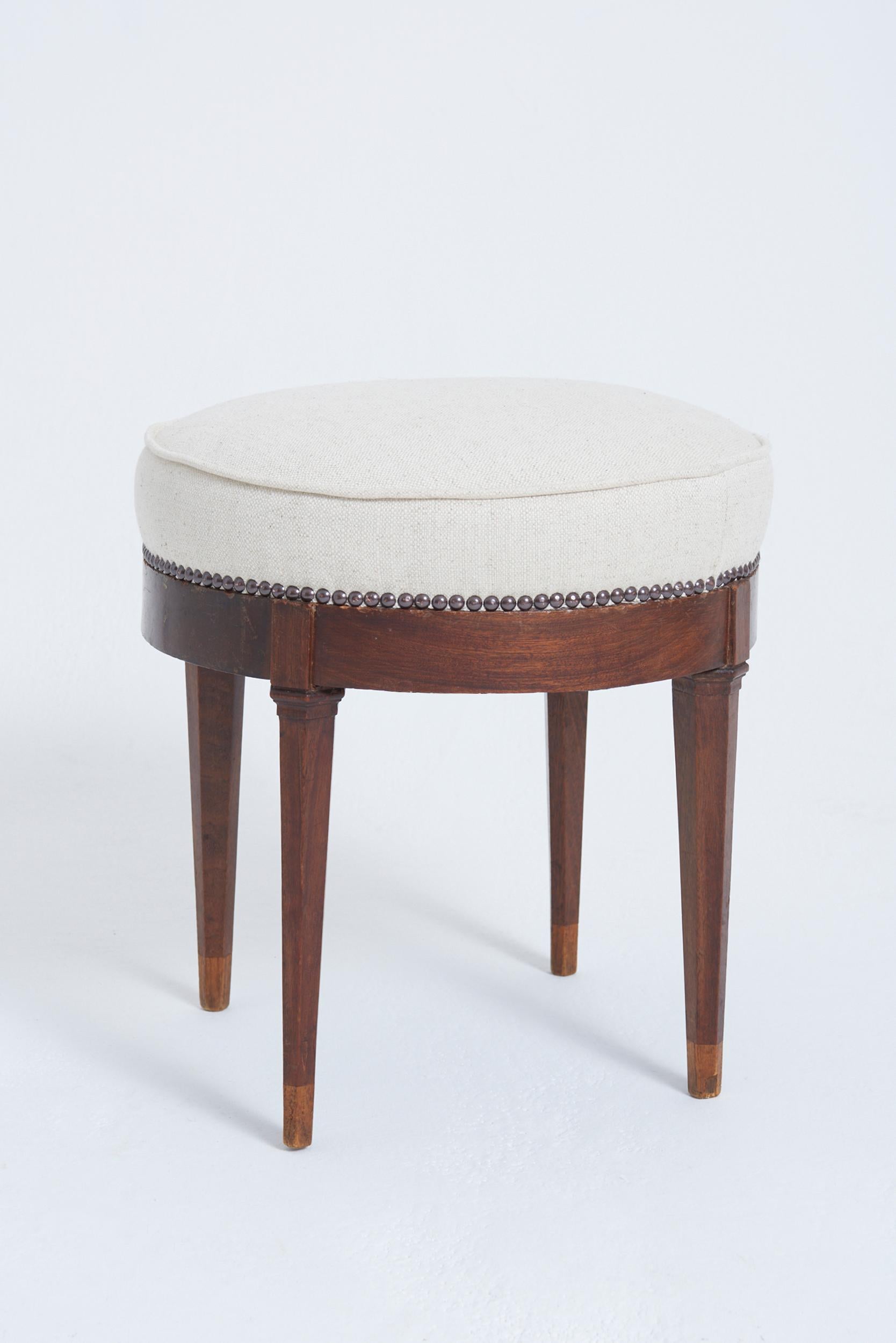 A pair of Neoclassical mahogany stools, on hexagonal tapered legs
France, Circa 1940
