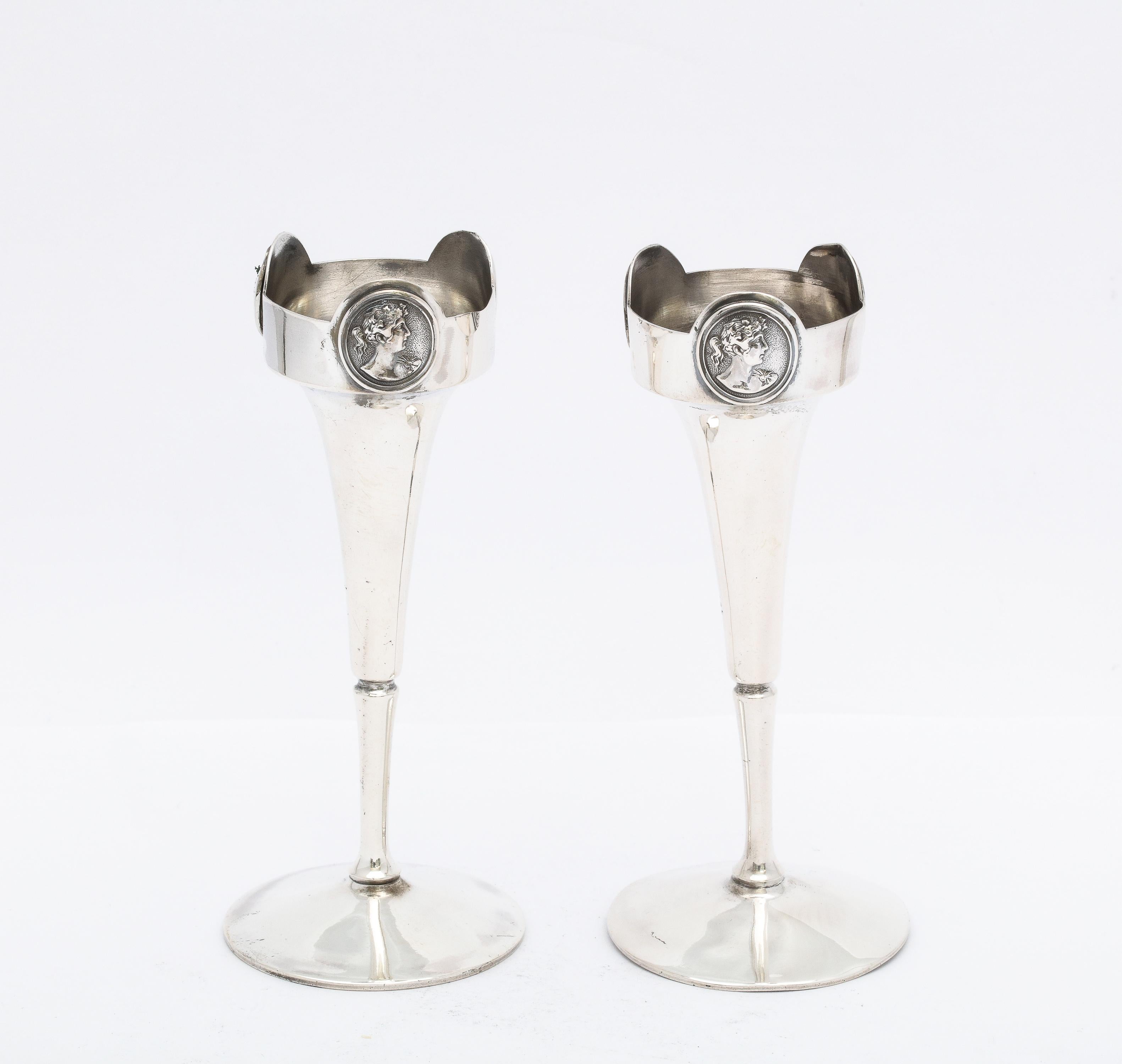 Pair of American Coin Silver (.900), Neoclassical-style Medallion bud vases, Gorham Mfg. Co., Providence, Rhode Island, Ca. 1875. Each vase has 3 lovely Neoclassical medallions around the rim of its opening. Each bud vase measures 4 1/2 inches high