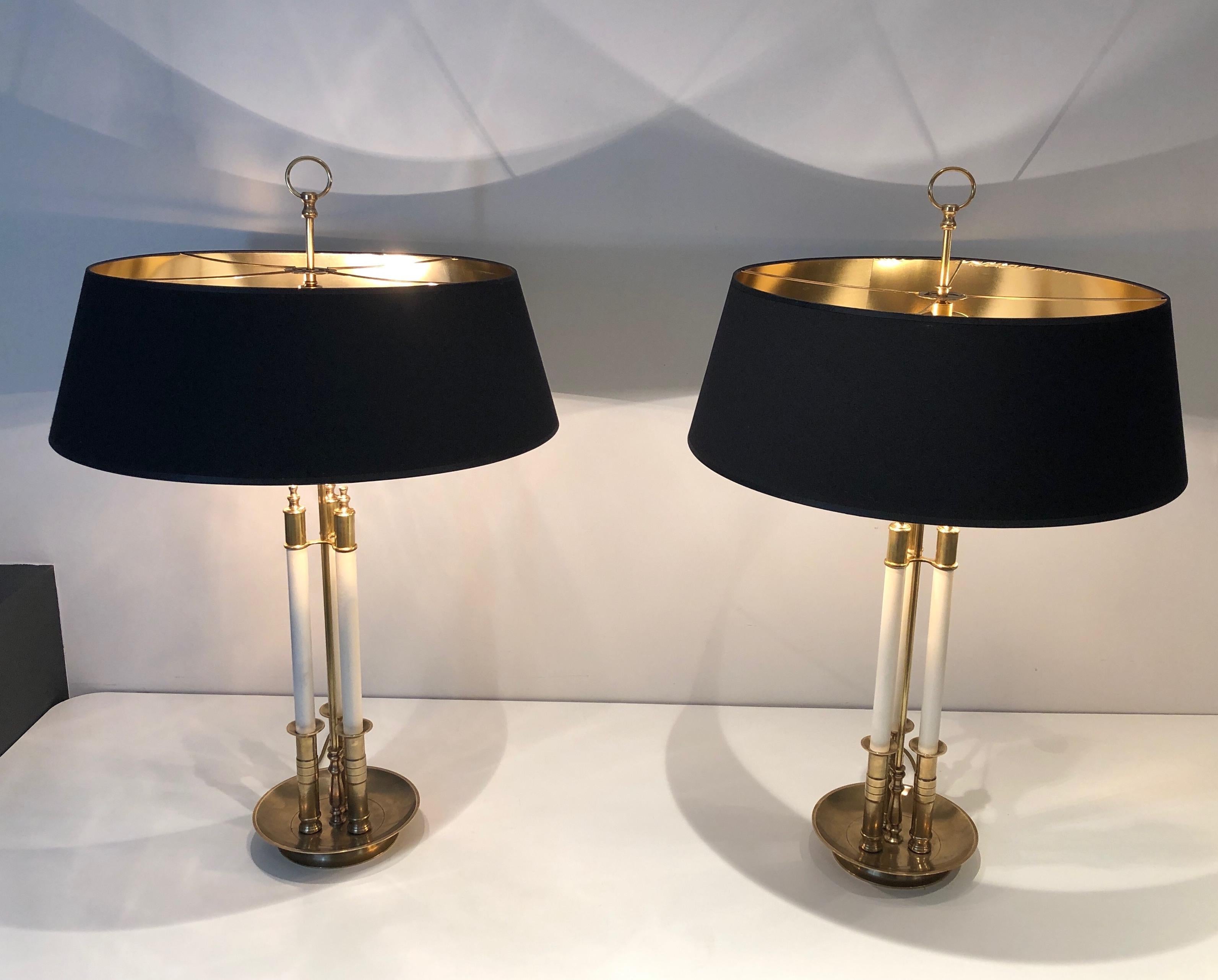 This very elegant pair of neoclassical style table lamps is made of brass with  white lacquered elements. This is a French work. Circa 1970