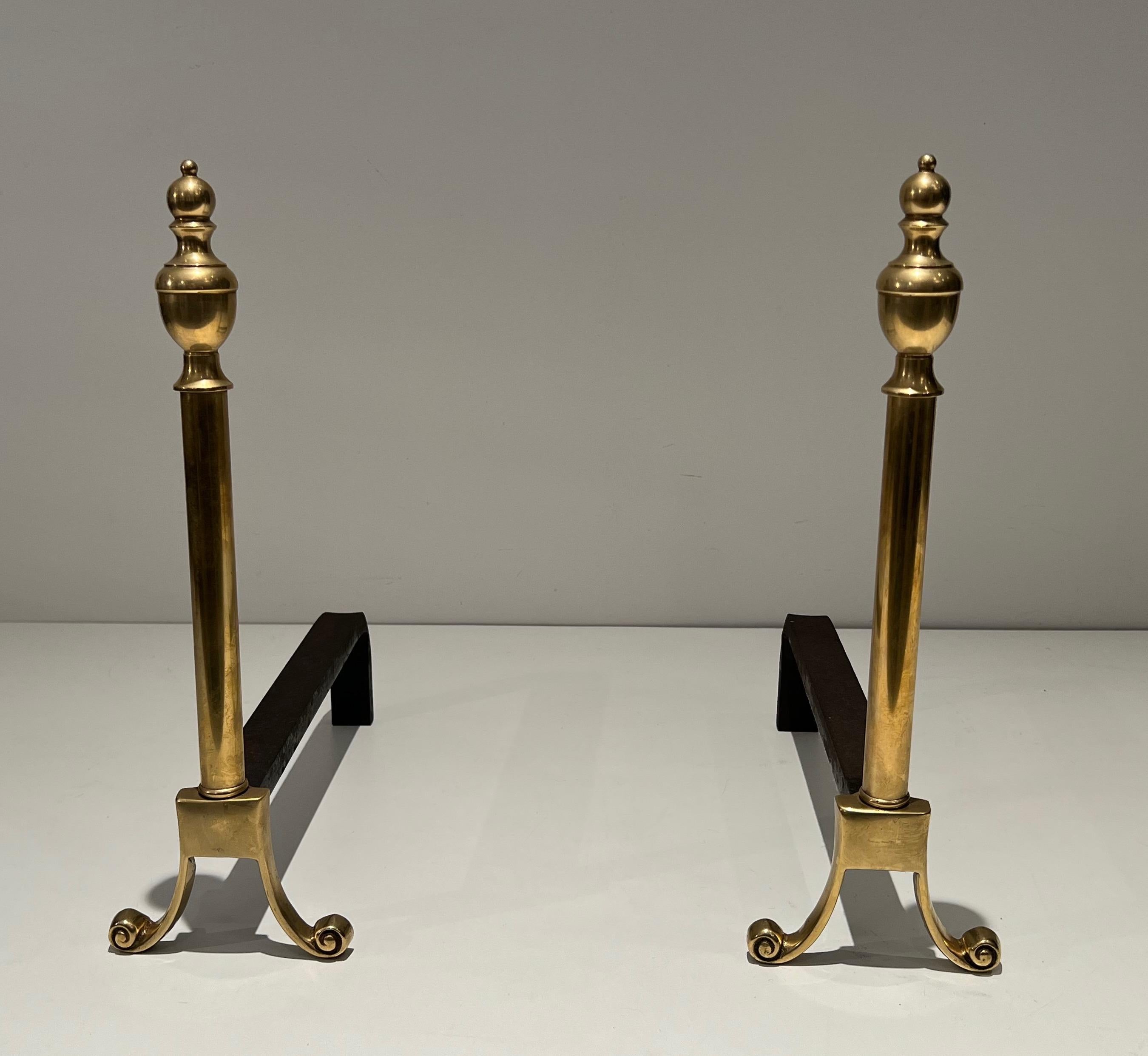 This pair of neoclassical style andirons is made of bronze and wrought iron. This is a French work. Circa 1940.