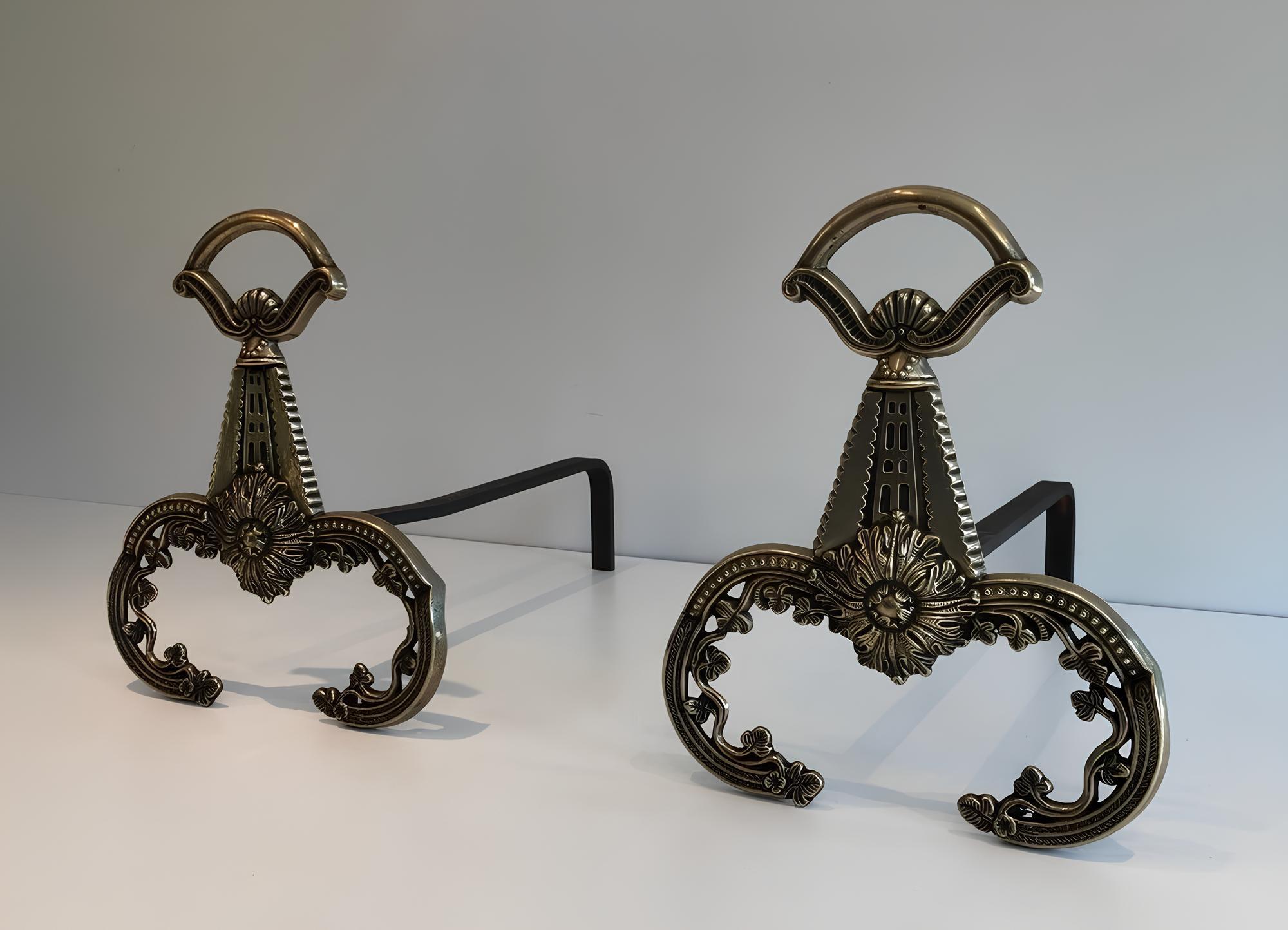 This pair of neoclassical style andirons is made of bronze. This is a French work. Circa 1900