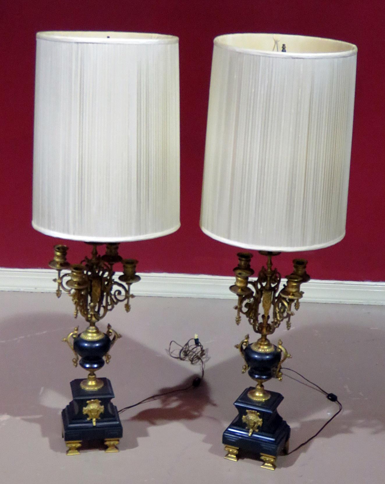Pair of neoclassical style 4-light candelabra lamps with one standard socket, shade, and brass accents.