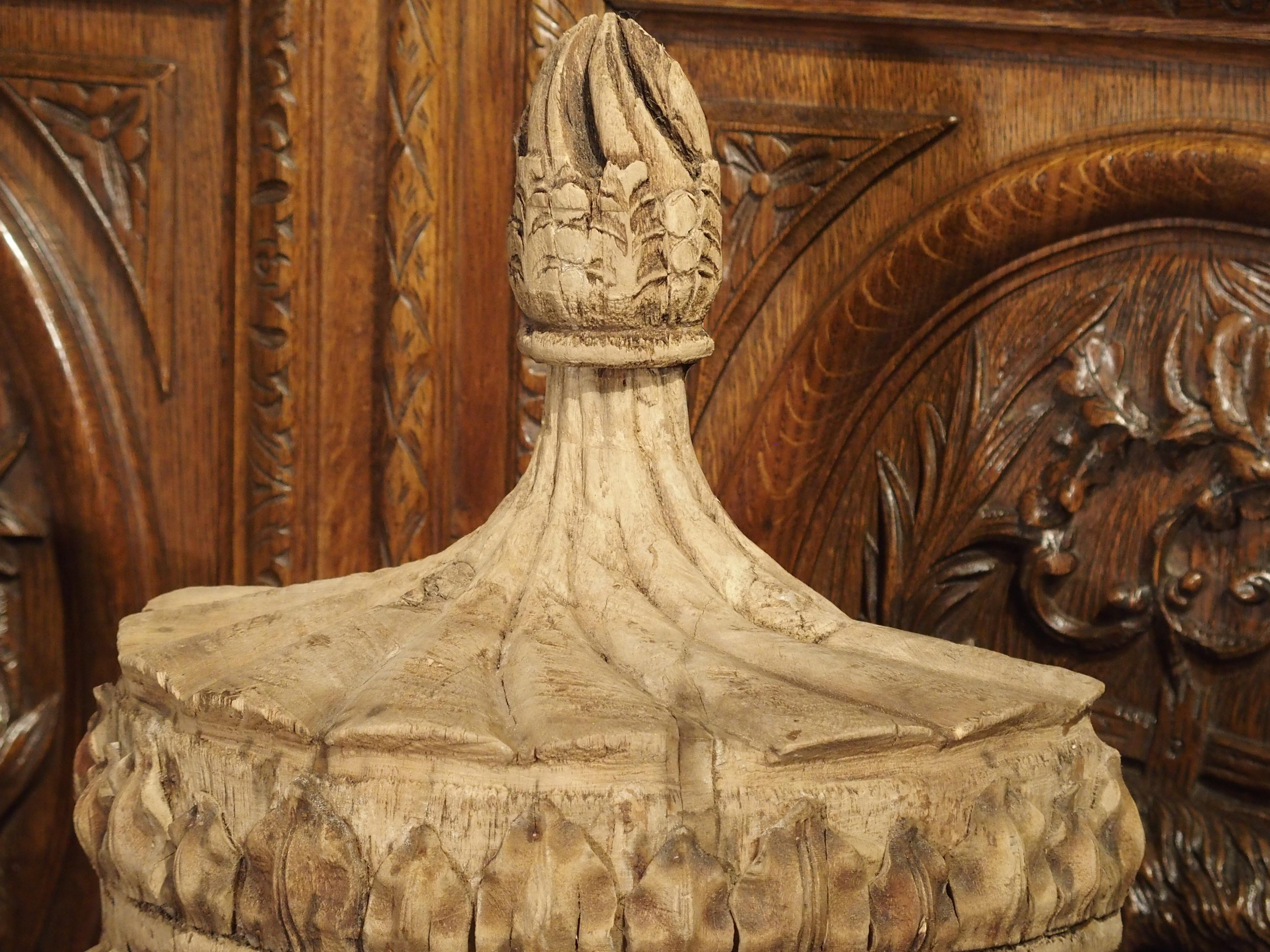 These elegant hand carved, wooden half urns are in the neoclassical style of England. The main theme of these half urns is the display of foliate motifs, with the encircled stylized sunflowers being the only exception. Separate, larger leaves have