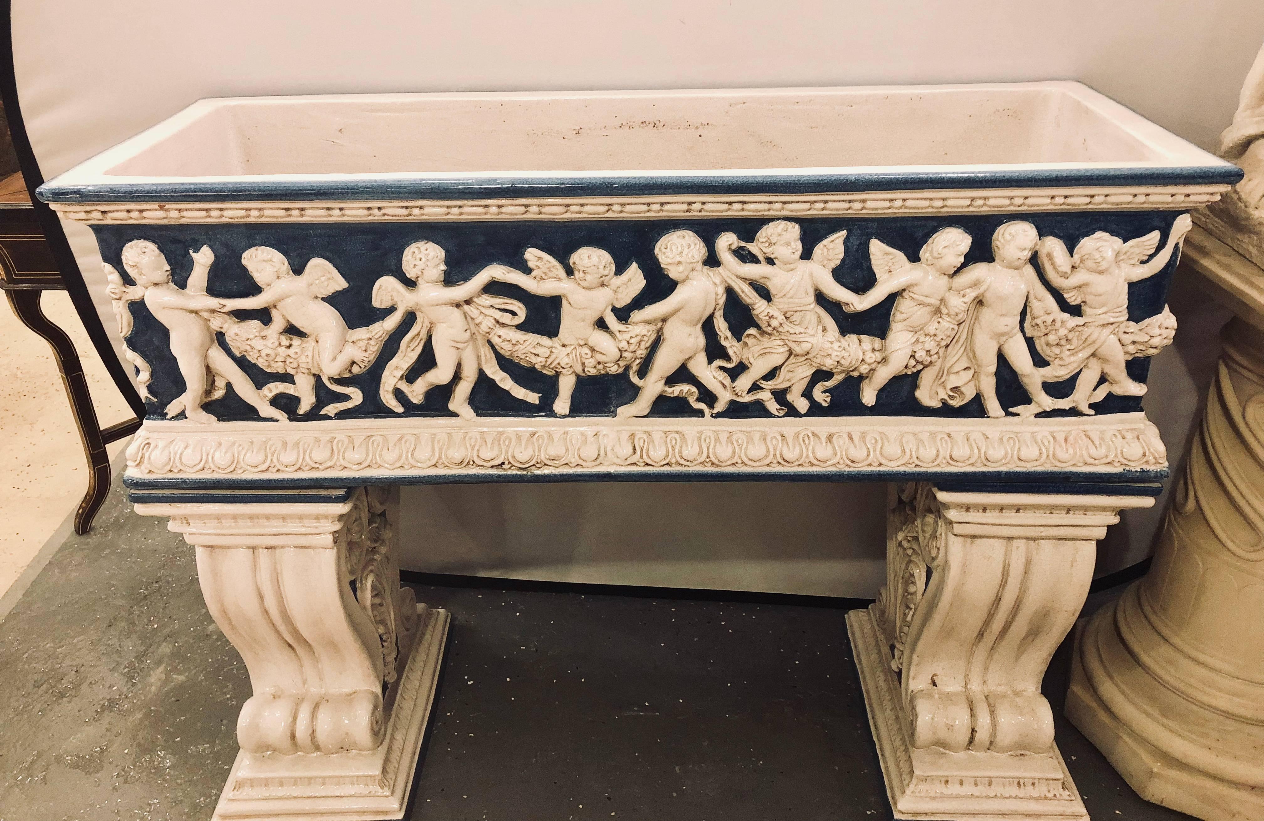 Pair of Neoclassical Style Ceramic Planter Tops Depicting Cherubs Dancing In Good Condition In Stamford, CT