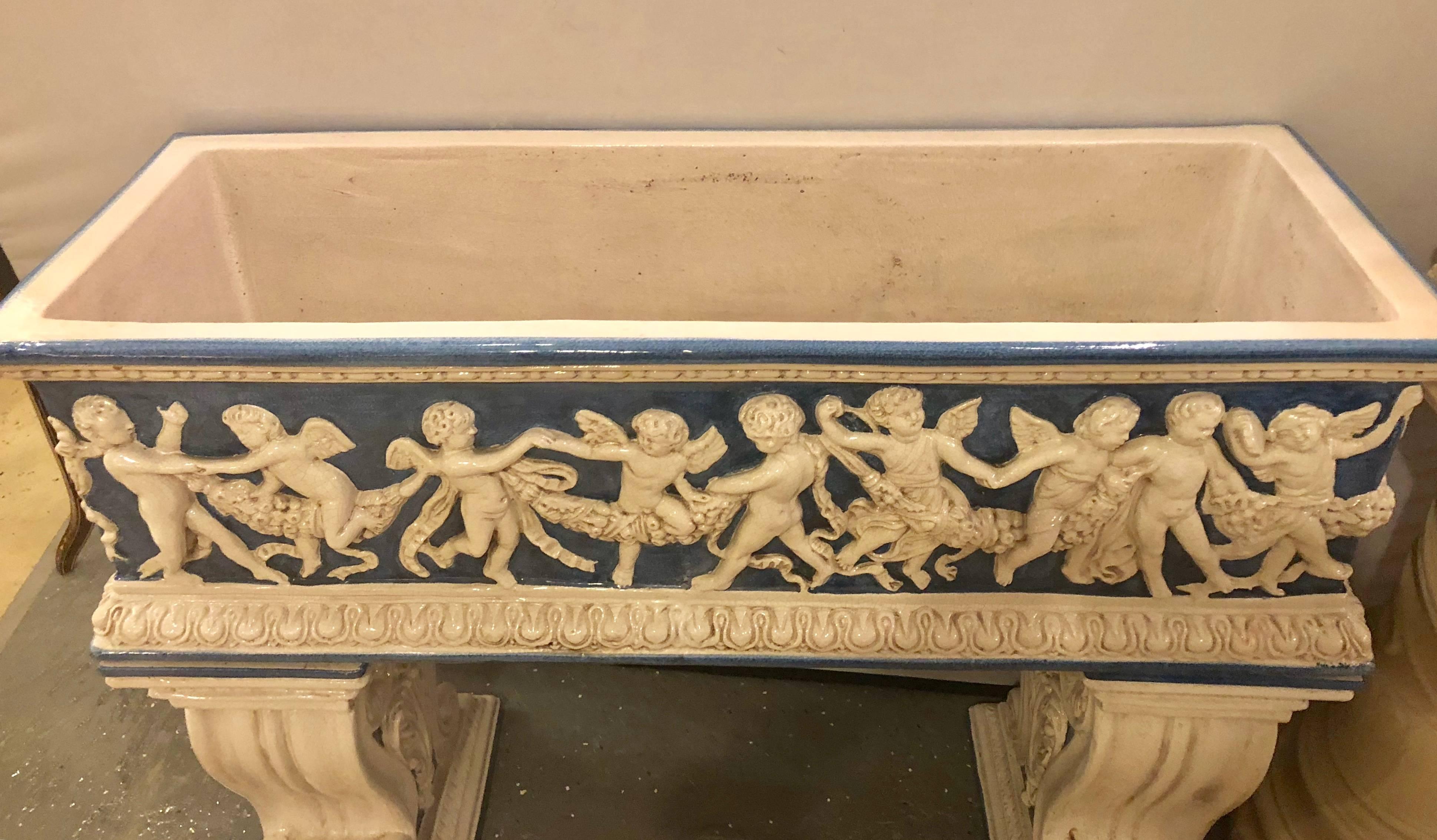 20th Century Pair of Neoclassical Style Ceramic Planter Tops Depicting Cherubs Dancing