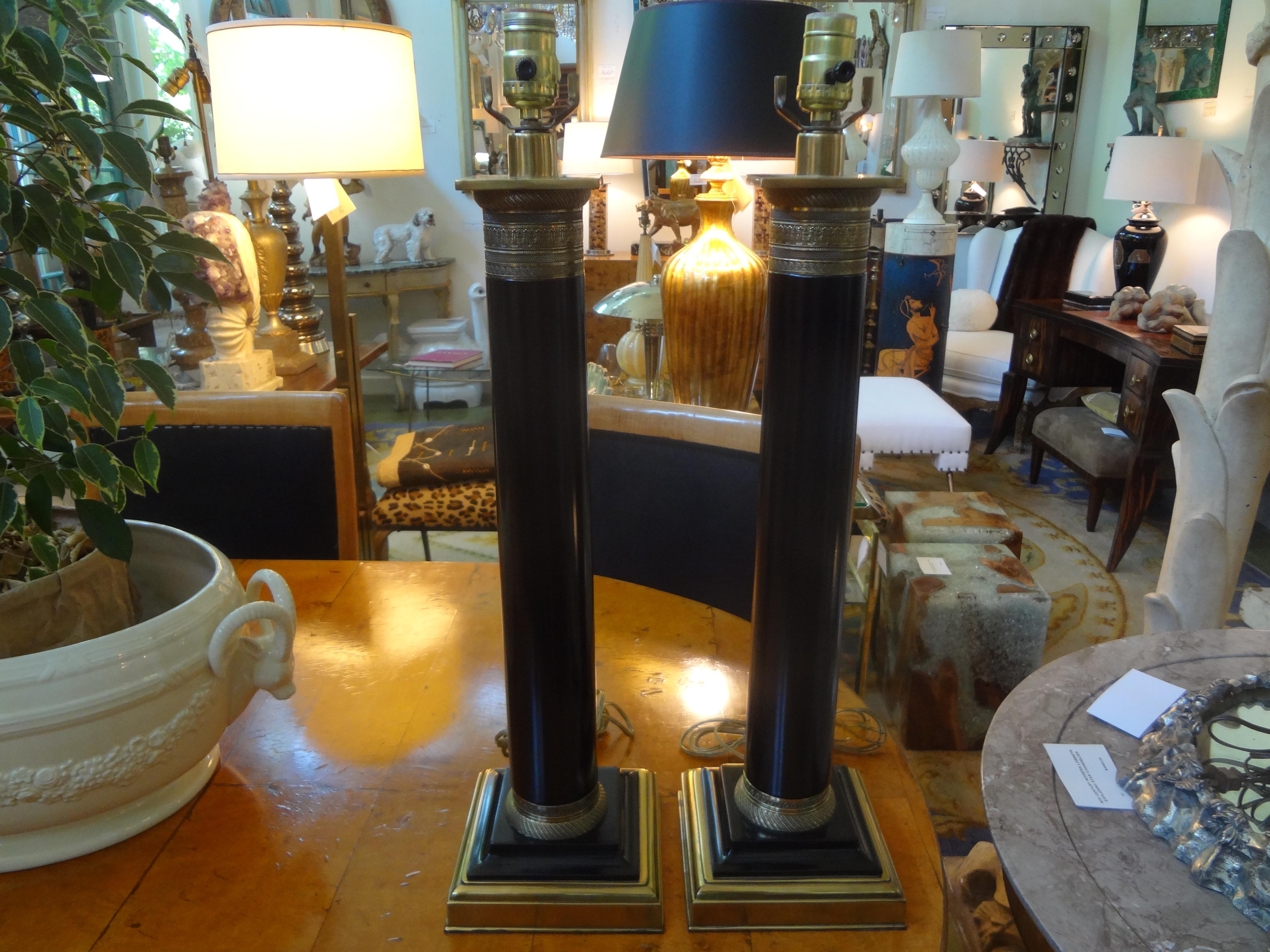 Large pair of neoclassical style tole column lamps with beautifully chased bronze detail. These stylish lamps would work well in a variety of interiors.