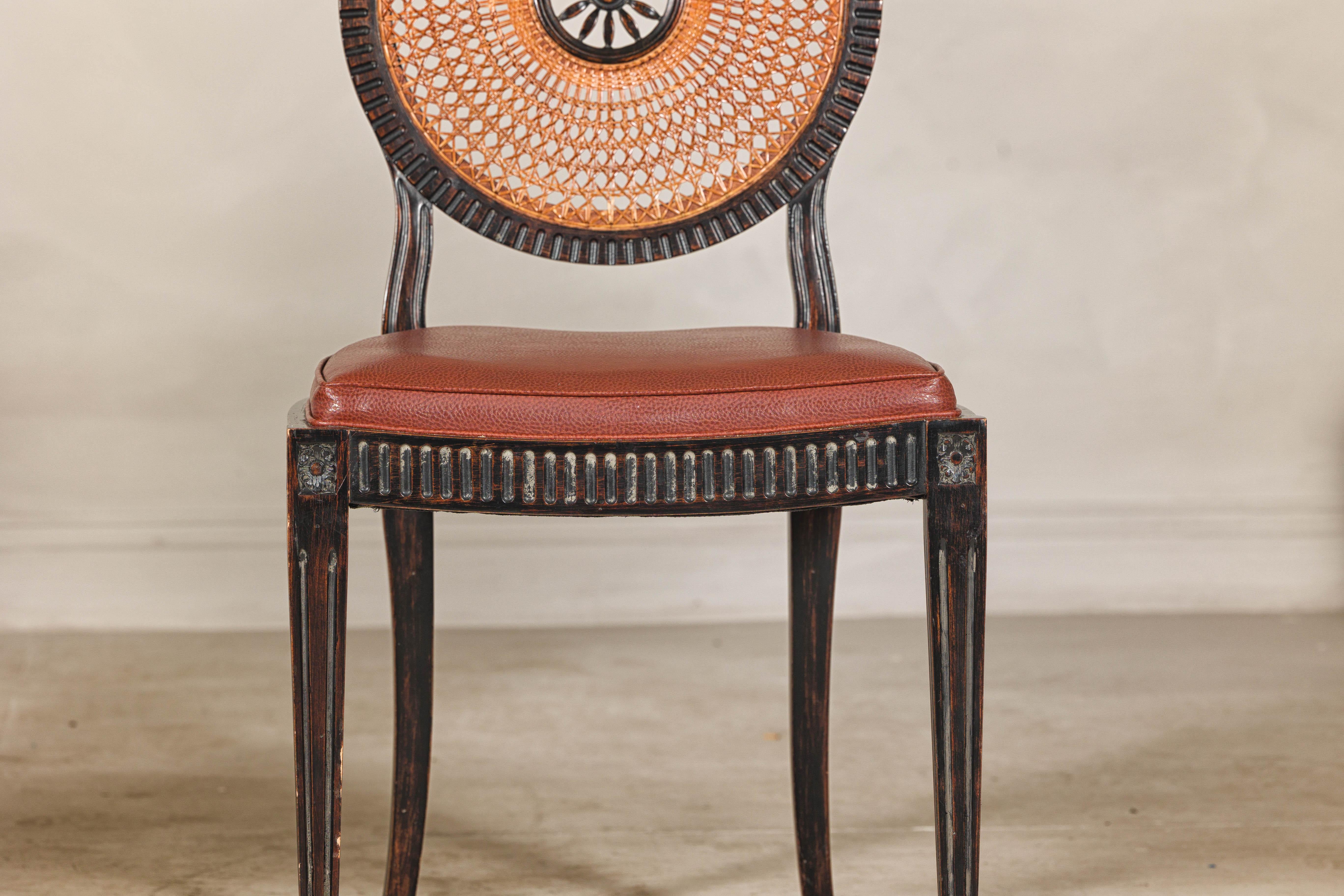 Carved Pair of Neoclassical Style Dining Chairs with Leather Seats and Rattan Backs
