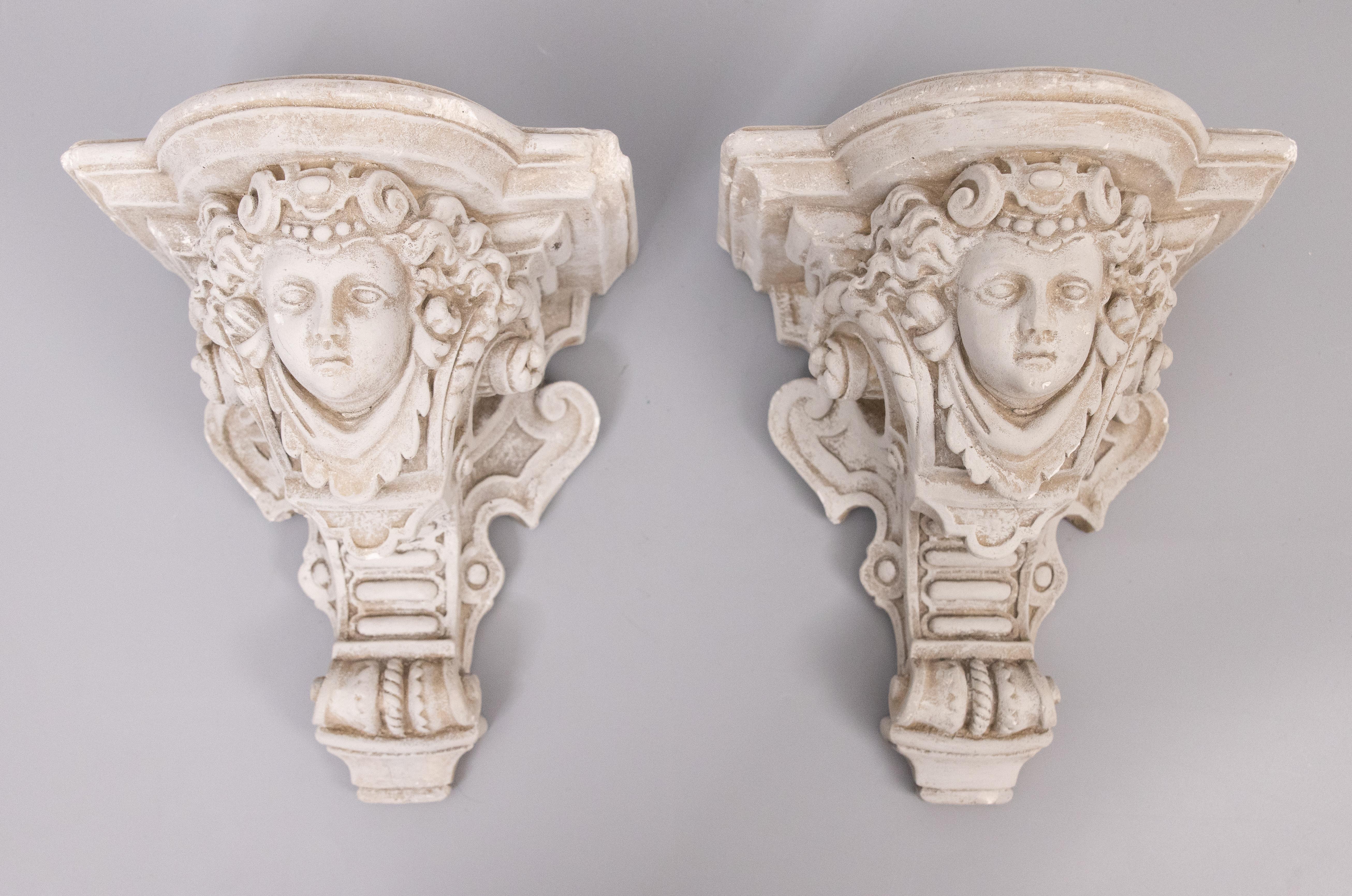 A fine pair of French architectural plaster cherub or putti brackets with a Neoclassical design, circa 1950. These gorgeous corbels have a lovely gray patina and are a nice large size and heavy, together weighing over 11 lbs. They would be perfect