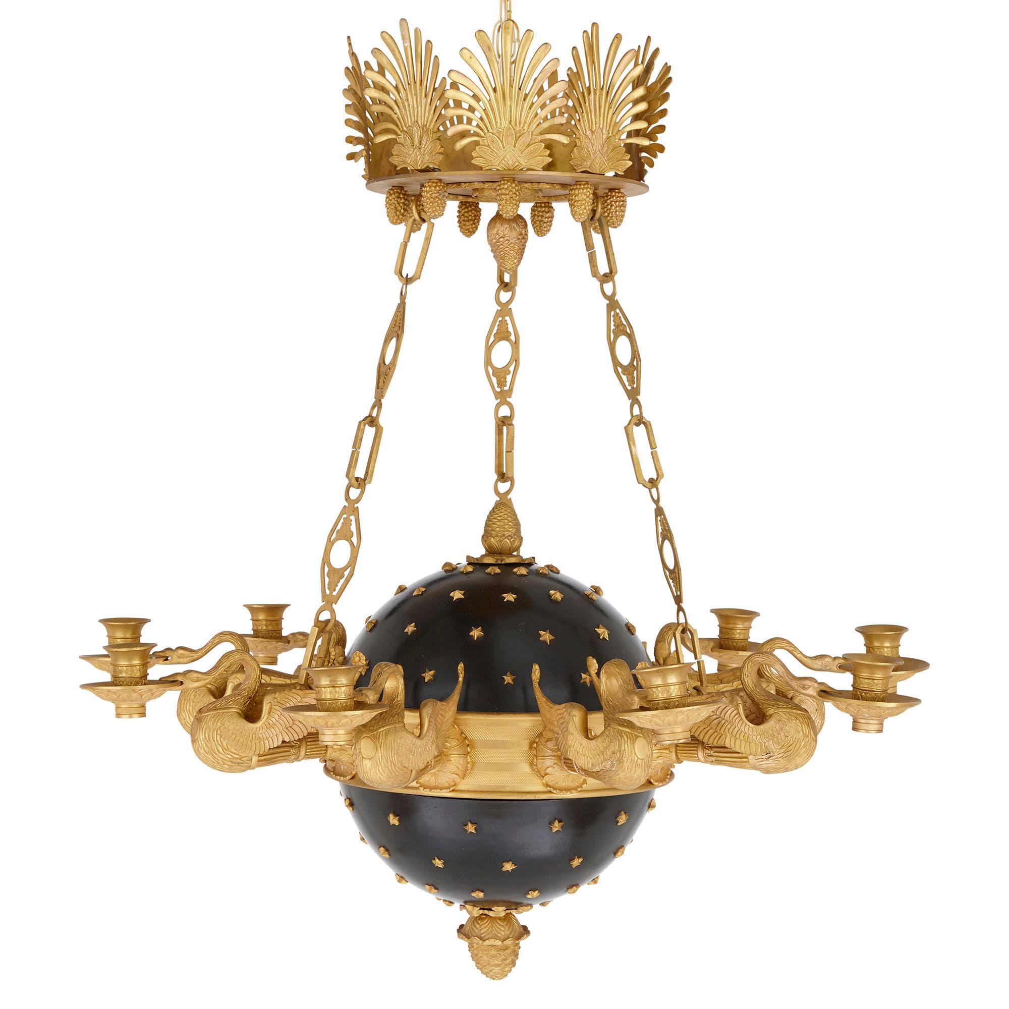Designed to mimic the appearance of a star-studded celestial globe, theses Empire style chandeliers are simultaneously charming and outstandingly beautiful. Each chandelier is designed about a metal globe—painted black—that is studded with gilt