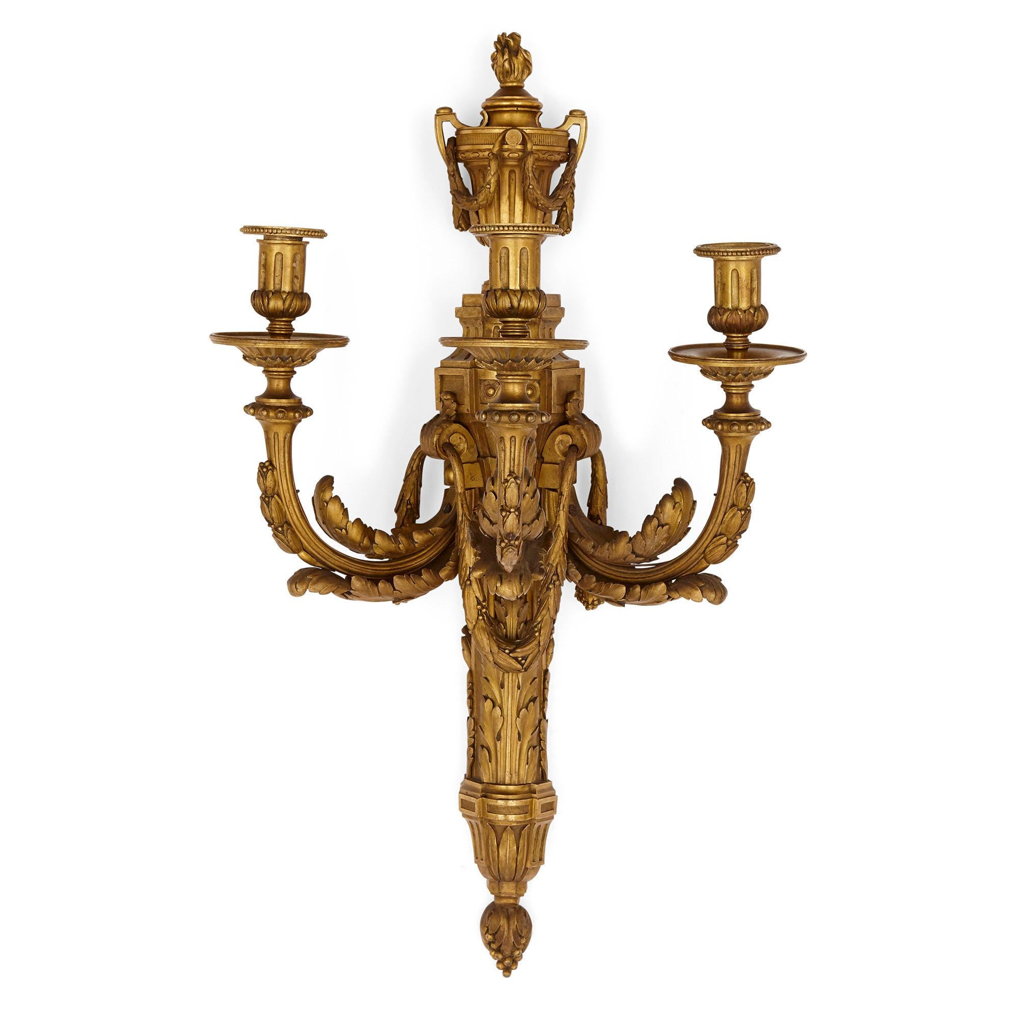 Pair of neoclassical style gilt bronze sconces
French, late 19th century
Measures: Height 74cm, width 43cm, depth 34cm

This fine pair of sconces is crafted from gilt bronze in the neoclassical style. Each sconce supports three light branches,