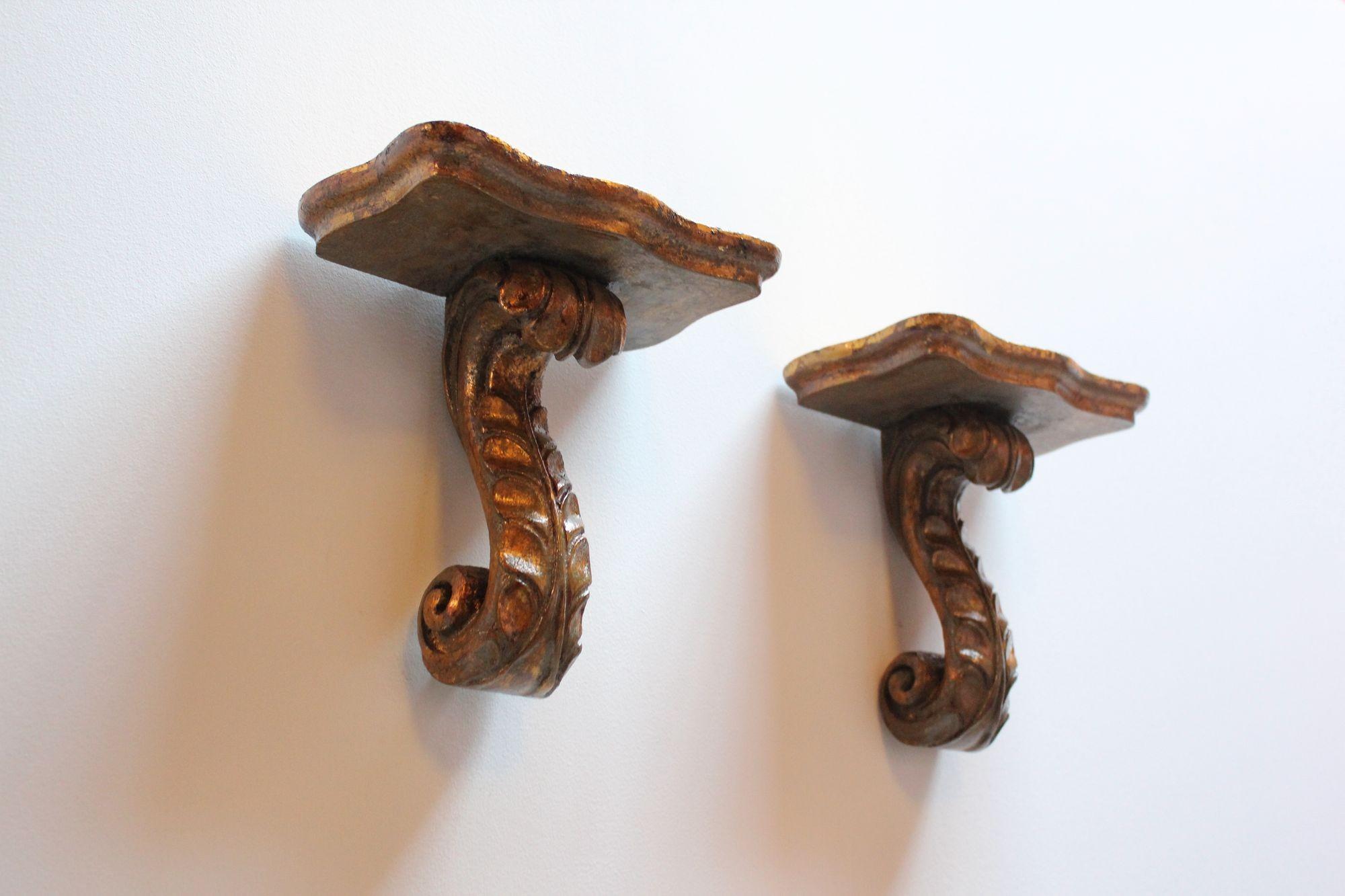 Pair of petite Neoclassical-Style giltwood scroll-form brackets/shelves. Beautiful patina with wear consistent with age/use (gilt losses and scuffs, as shown).
Measures H: 8.5