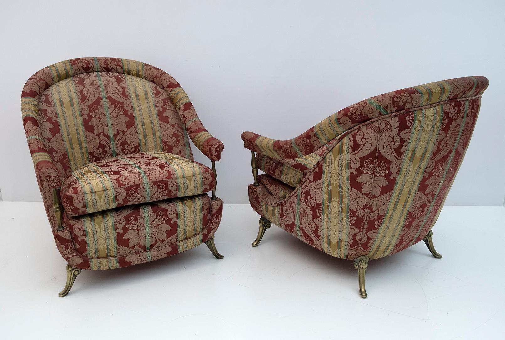 Pair of neoclassical style armchairs, with feet and columns to support the armrests, in brass. The upholstery was redone twenty years ago but is worn and stained, a new upholstery is recommended. Italian production of the 1950s.