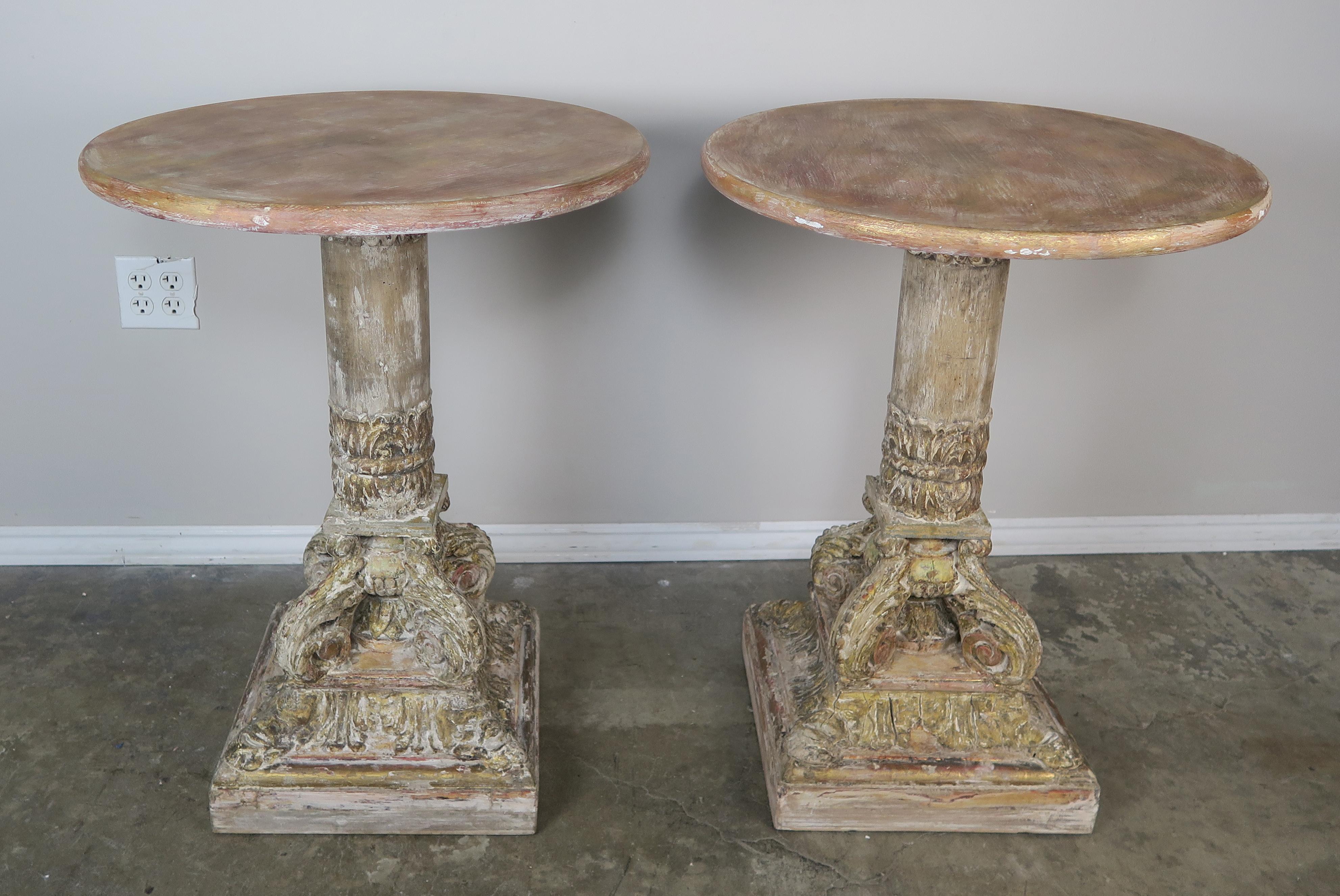 Pair of carved wood painted neoclassical pedestal style tables.