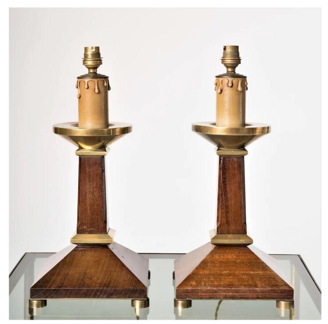 Elegant pair of 1960s French neoclassical style table lamps. Mahogany and brass accents. Faux candle socket decor. Price includes rewiring for the US. Minor dent on one of the lamps as shown on pictures (on the back side). Minor scratches. Else in