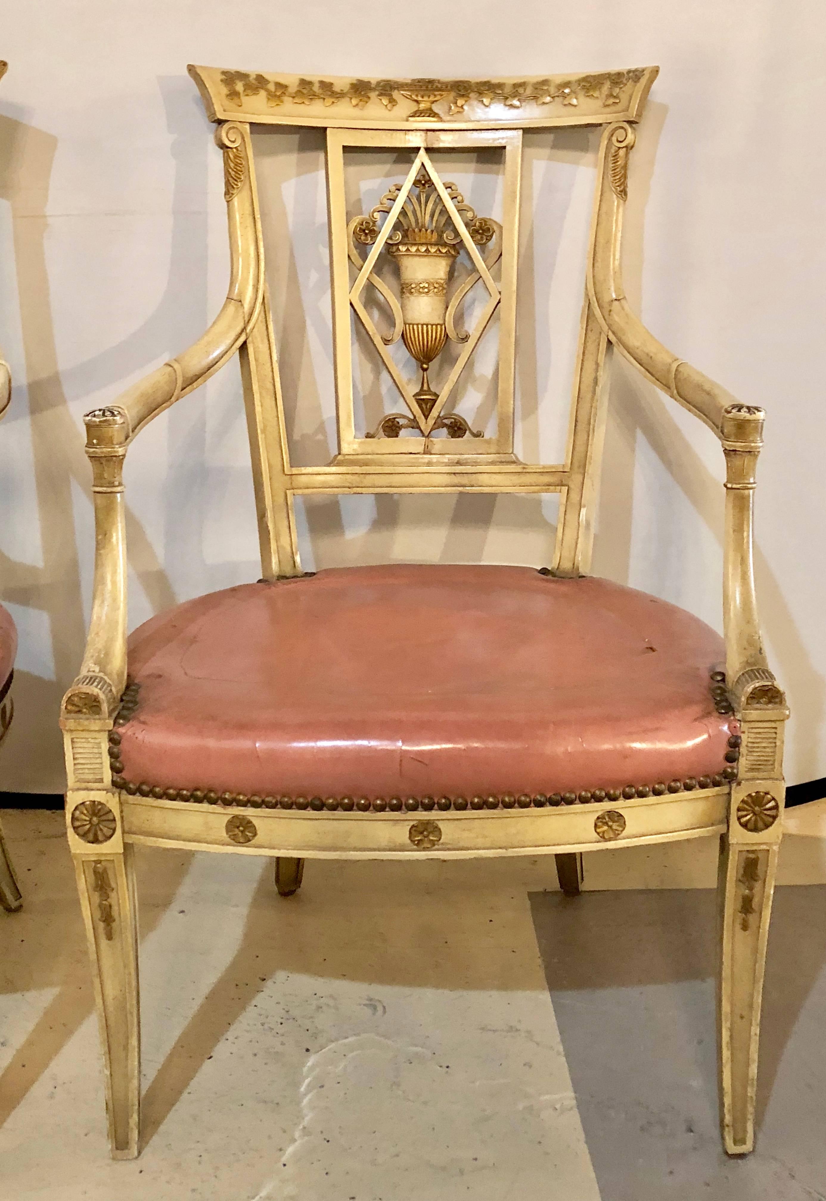 A pair of neoclassical style Maison Jansen armchairs or fauteuils. Part of an original set of twelve documented dining chairs this fine pair of Fauteuils are simply the finest in quality by this iconic designer. The warm worn whitish finish with
