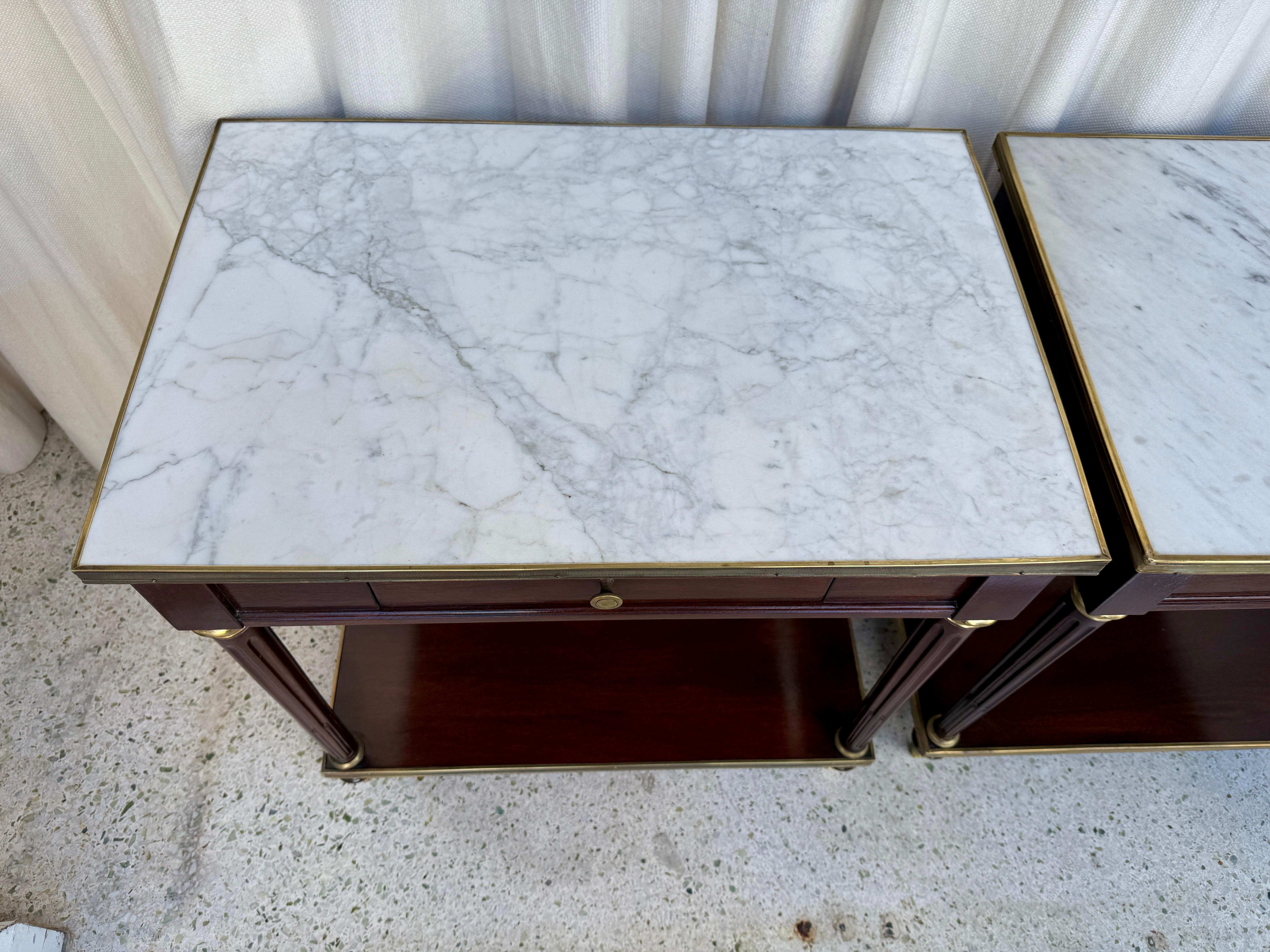 Beautiful single-drawer night tables by Maison Jansen.  Mahogany, Carrara marble and brass fittings throughout.  ALL original and in beautiful condition.