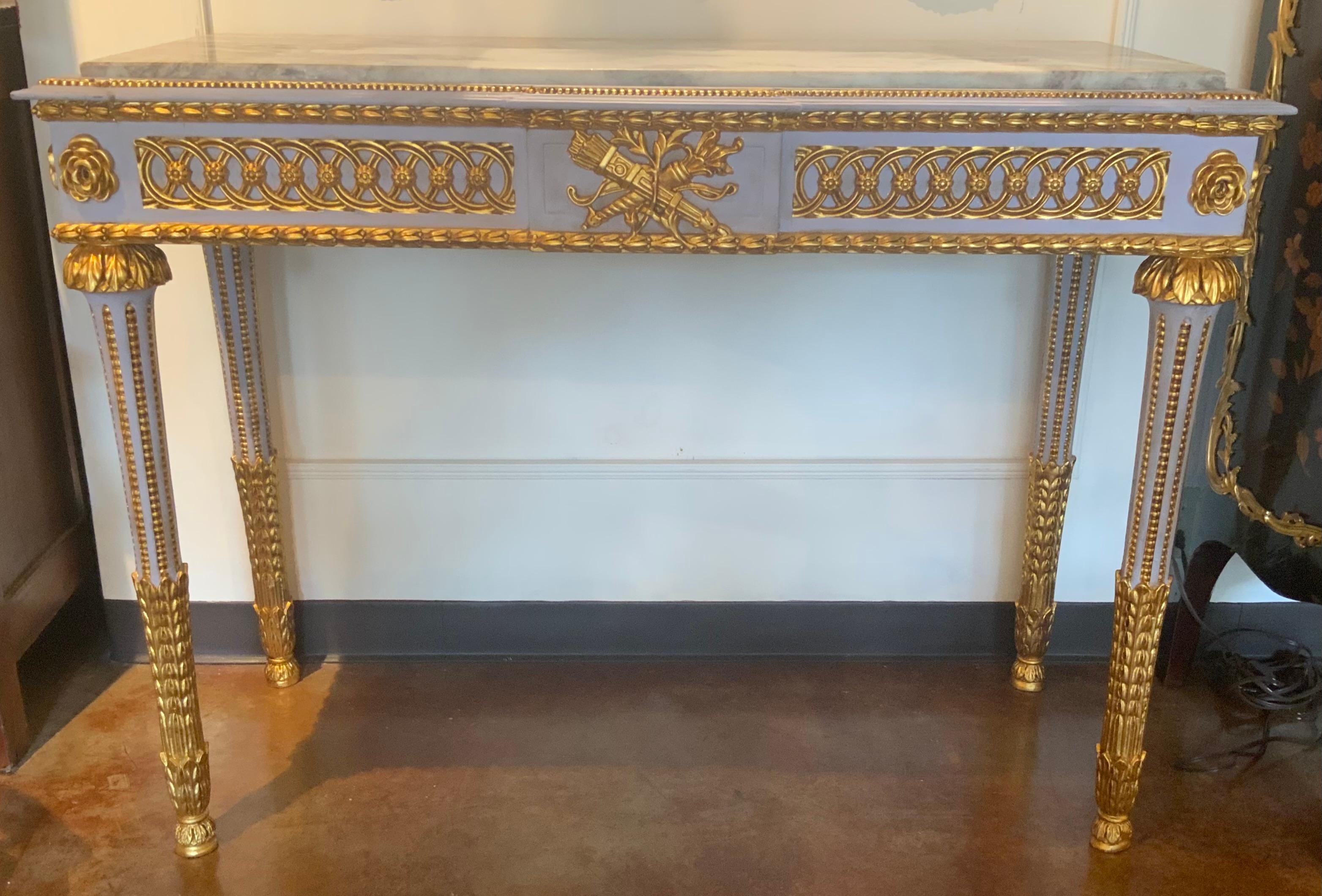 This pair has great detail in the carving each having rectangular 
Marble top, above central crossed torch and quiver of arrows
Flanked by molded frieze, rising on fluted legs, ending on fluted
Legs, ending on foliate feet. The combination of gray