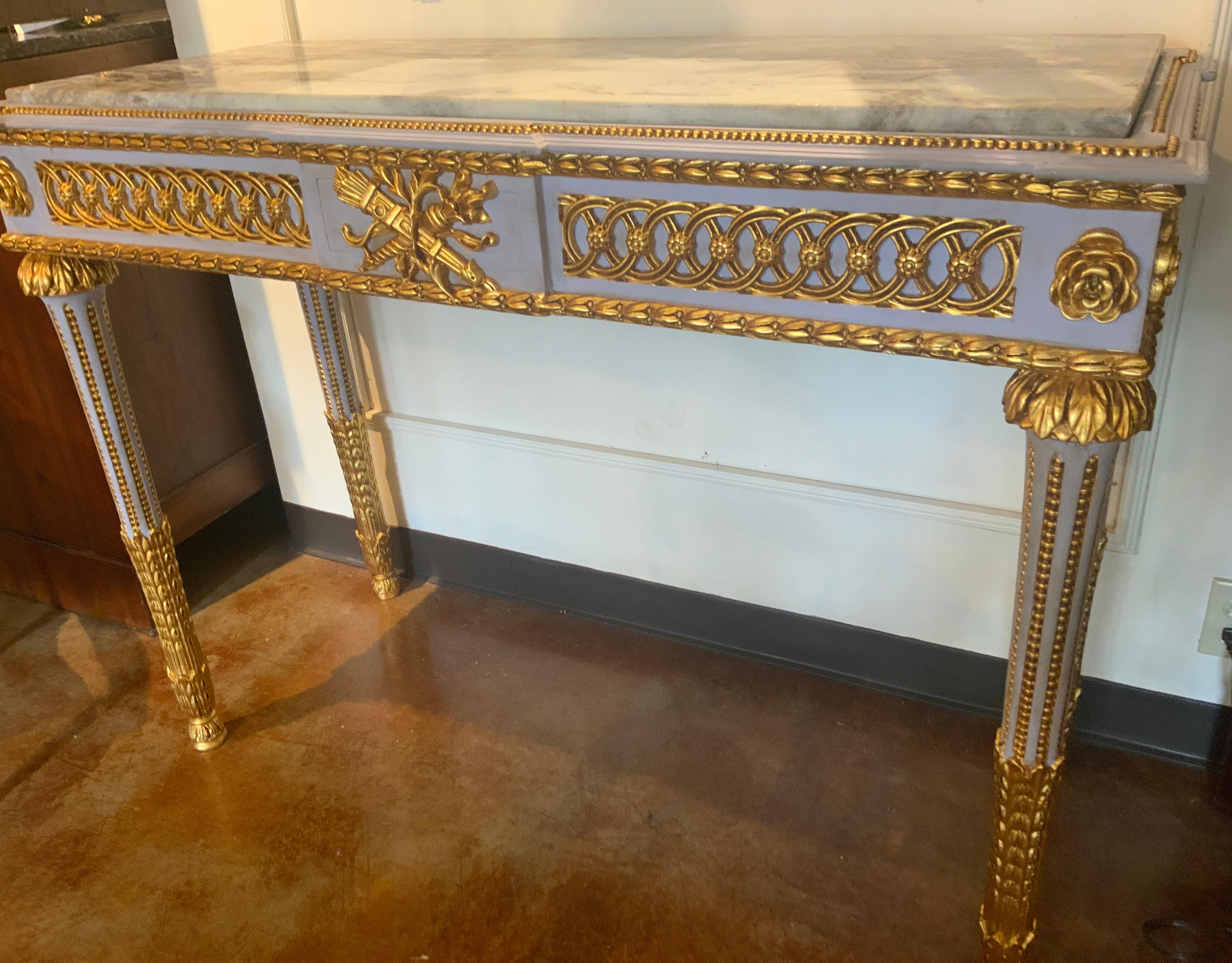 Pair of Neoclassical Style parcel gilt and gray painted marble top consoles In Excellent Condition For Sale In Houston, TX