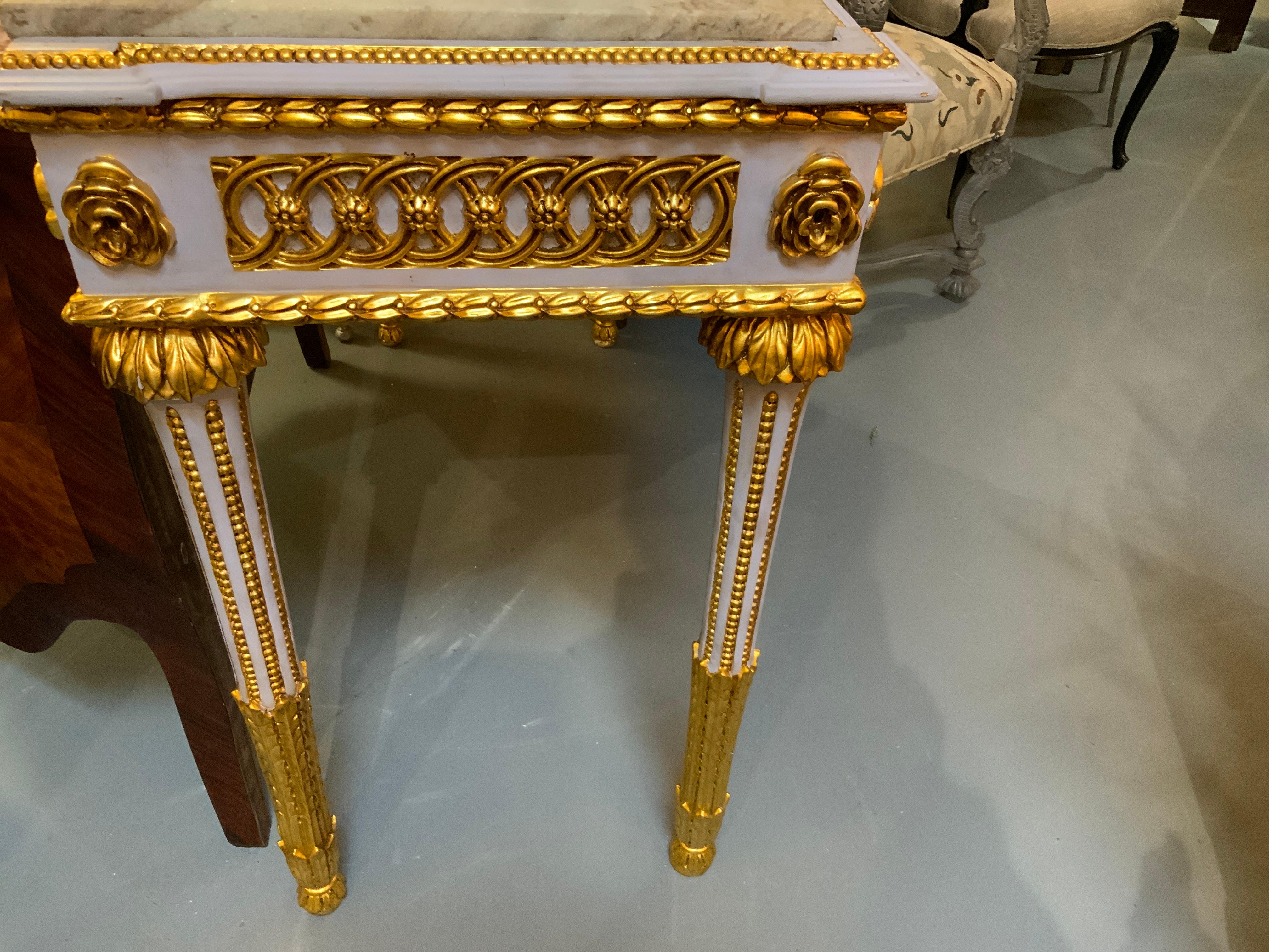 Pair of Neoclassical Style parcel gilt and gray painted marble top consoles For Sale 1