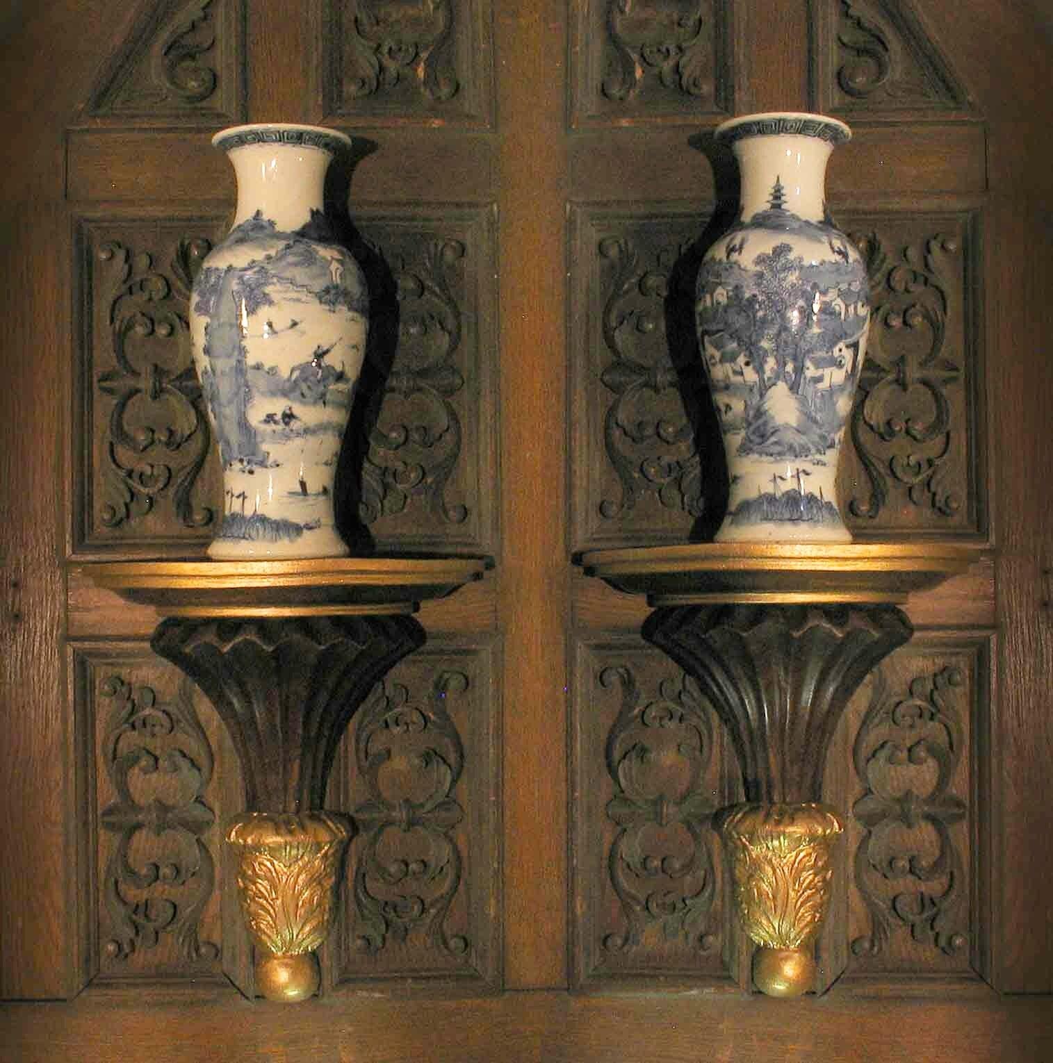 A pair of neoclassical style parcel gilt carved wood wall brackets, 20th century. The wall brackets have a semi-circular platform above a reeded, tapering support, descending to a terminal with acanthus leaves carved in relief. The brackets measure