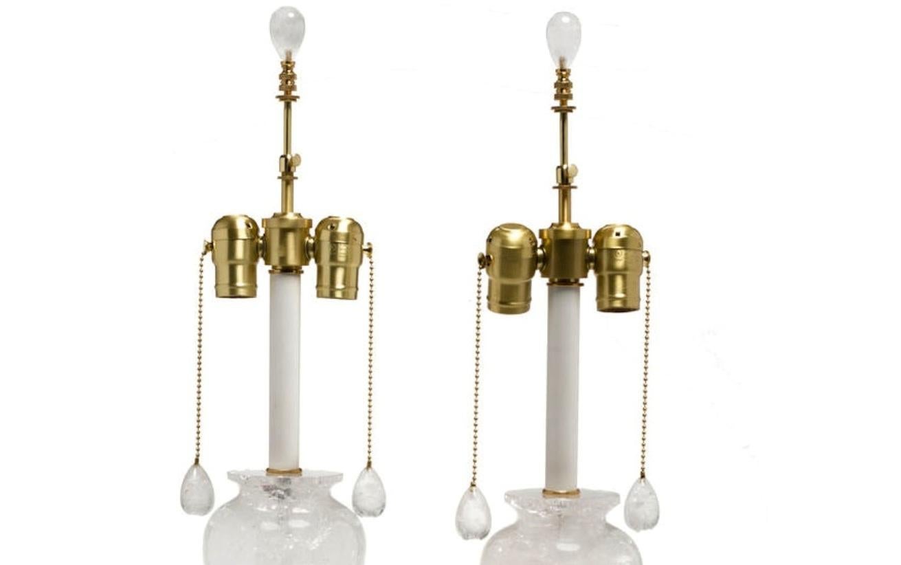 An exquisite pair of Neoclassical style ormolu mounted carved rock crystal urn-form table lamps.( A )
21st century.
Each lamp is centered with a hand carved and polished Rock Crystal ovoid shaped body, above a gilt bronze rosette and a conforming