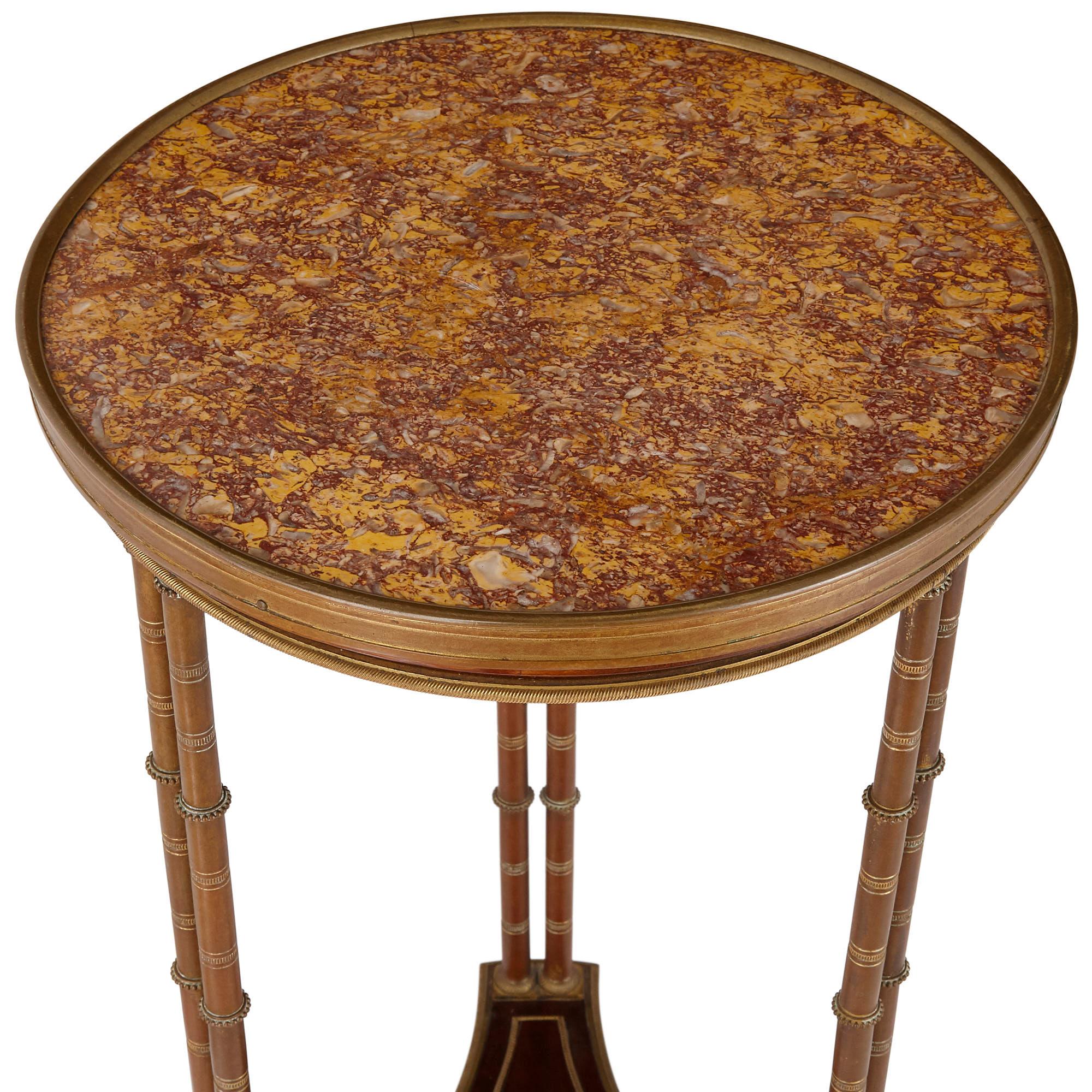 Pair of neoclassical style round side tables, manner of Adam Weisweiler
French, 19th century
Measures: Height 76 cm, diameter 37.5 cm

These exquisite round side tables, or Gueridon, are made in the French neoclassical style, in the manner of