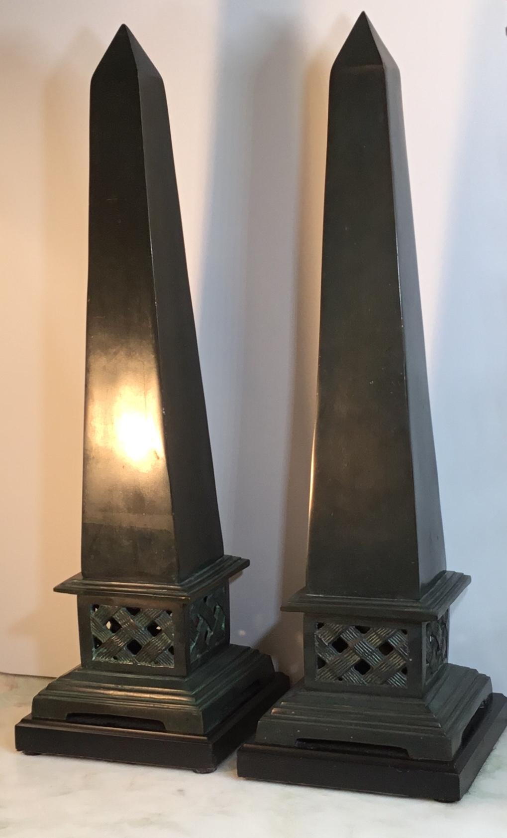 Elegant pair of obelisk made of solid bronze in dark green color, mounted on a black color brass base, beautiful object of art for display.