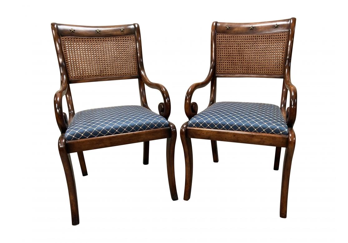 A pair of very well made Armchairs with solid wood frames having handsome graining with intentional distressing in a good polished medium  stain and the chairs feature Brass Star embellishments on the Crest rail front and top sides as well as