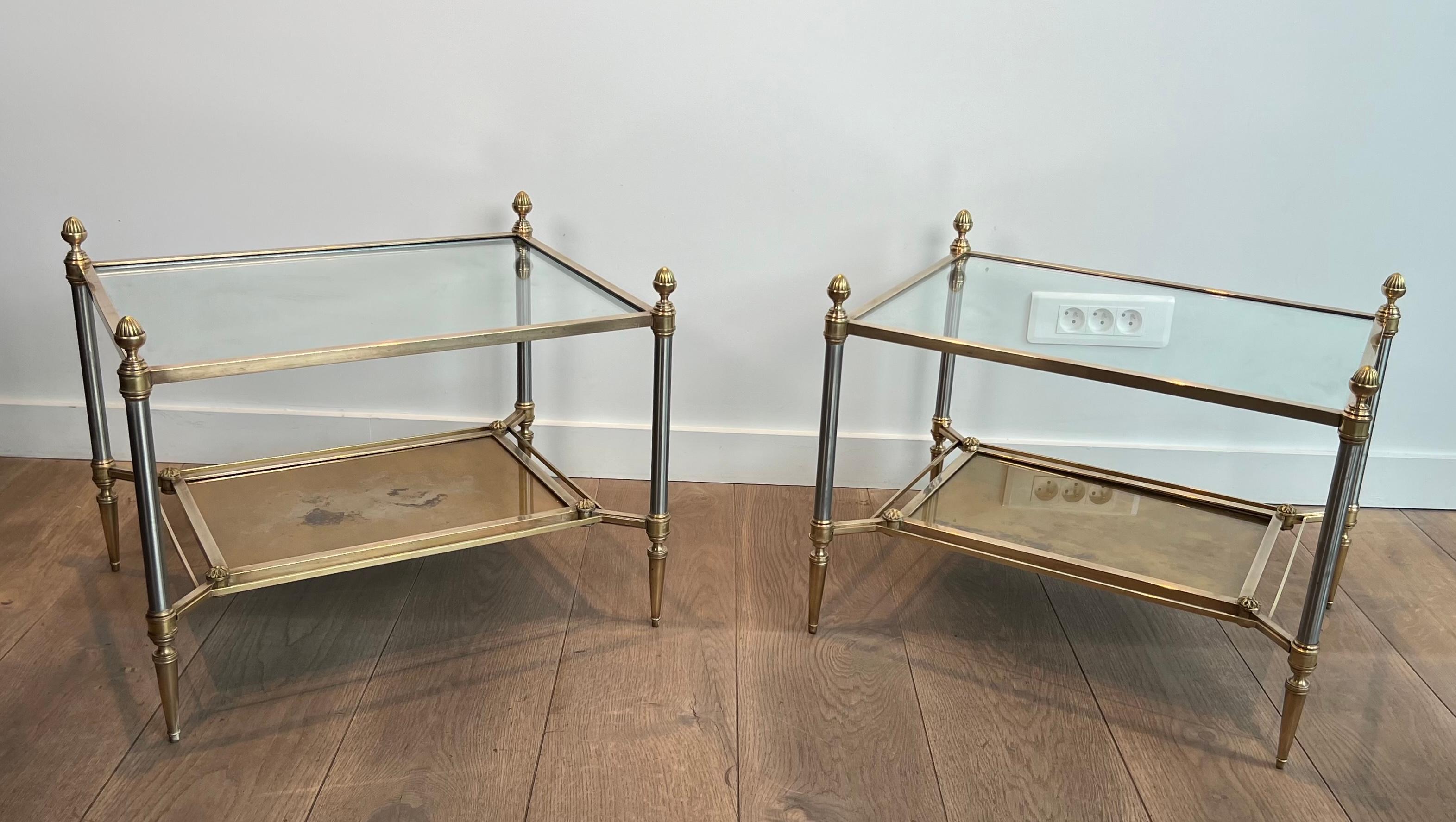 Pair of neoclassical style steel and brass side tables with clear glass top and gilt eglomised mirror on the bottom part. French work by Maison Jansen. Circa 1940
2 pairs available.