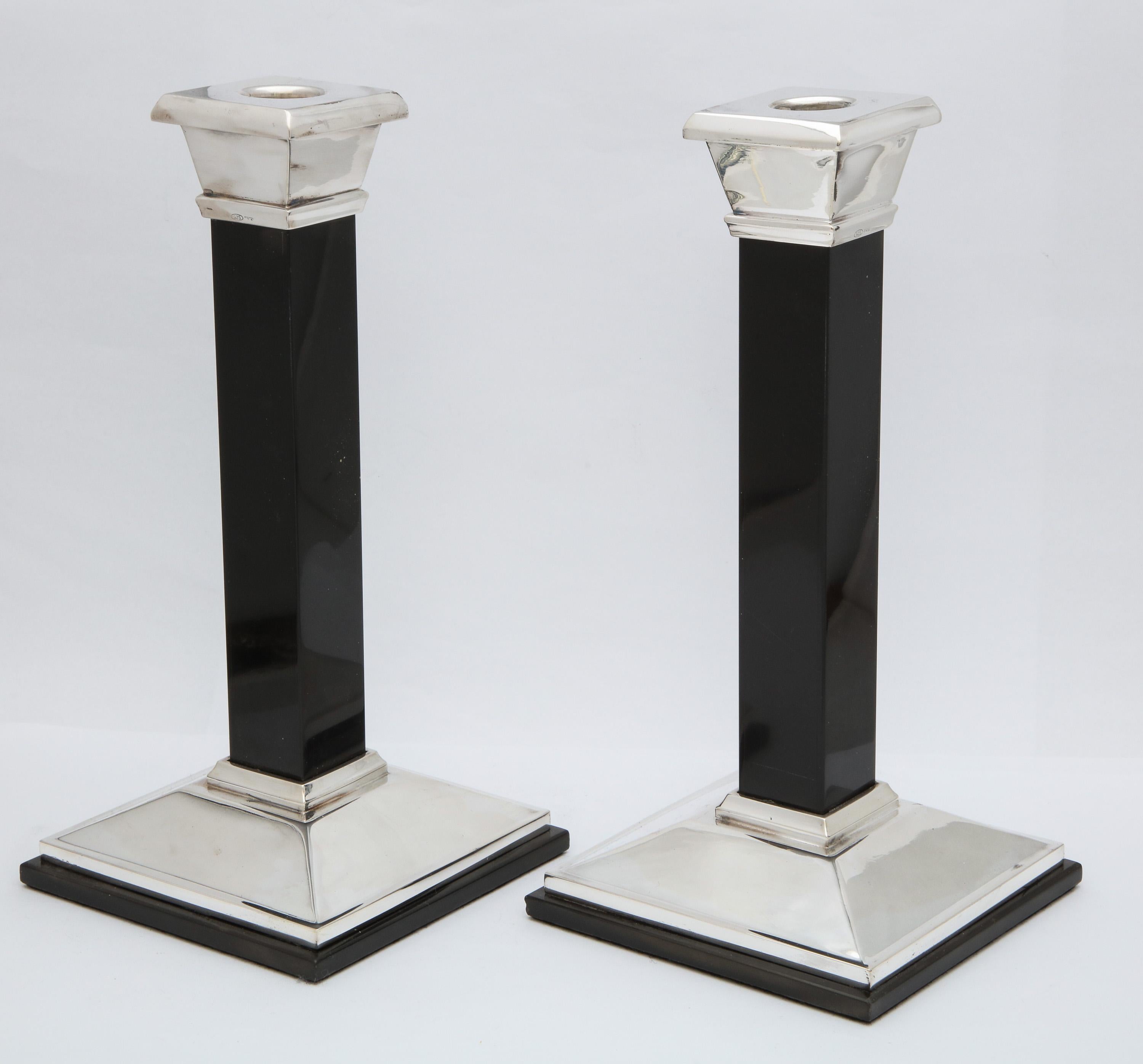Pair of tall, Neoclassical-style, sterling silver and black onyx candlesticks made for Tiffany and Co. in Italy and retailed in New York, circa 1980's. Weighted. The pair measures 9 3/4 inches high x 4 3/4 inches deep x 4 3/4 inches wide. Dark spots