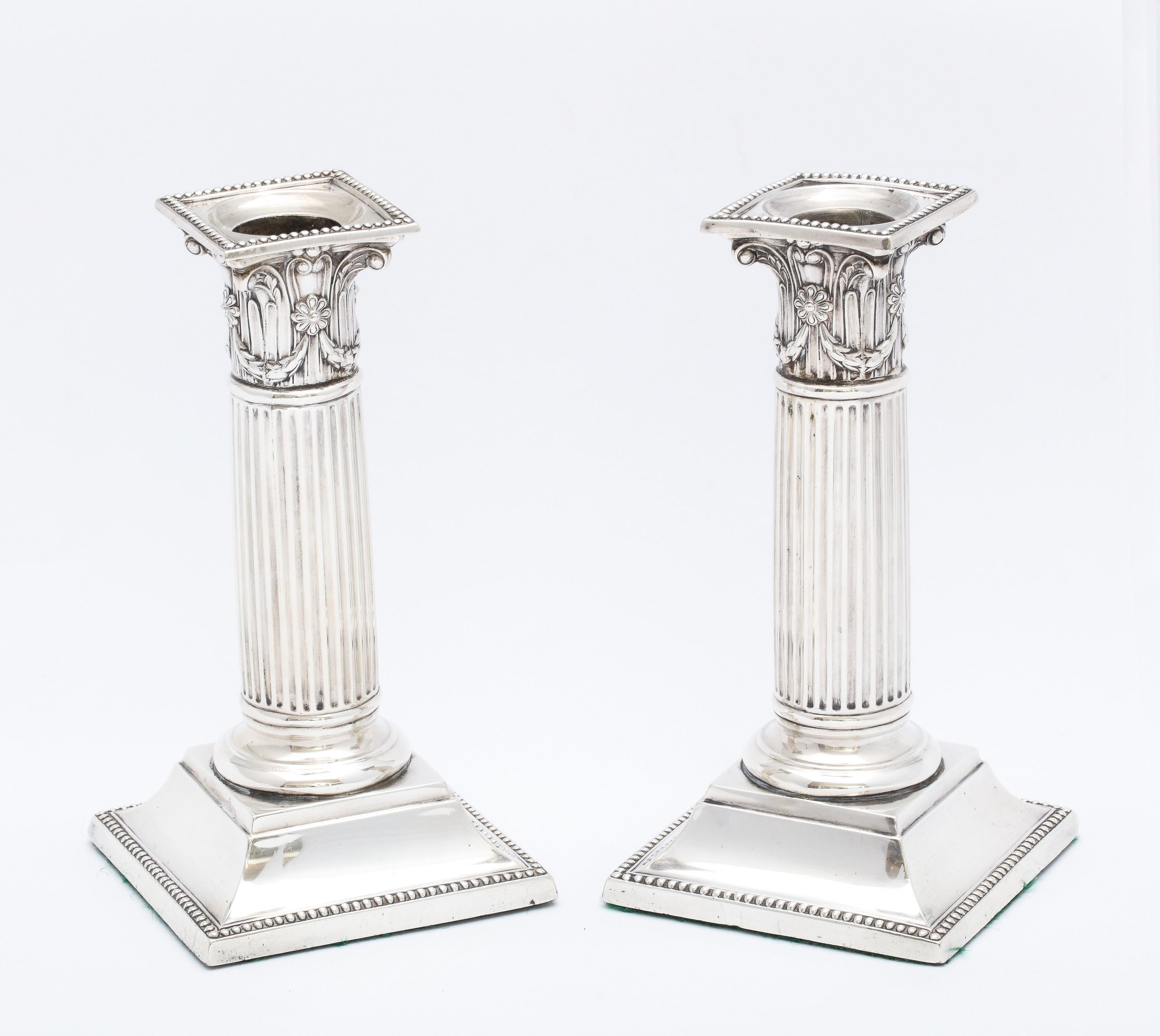 Neoclassical Style, Victorian Period, sterling silver Corinthian column candlesticks, Birmingham, England, year-hallmarked for 1889, Richard Martin and Ebenezer Hall (doing business as Martin and Hall) - makers.  Capital of each candlestick's column