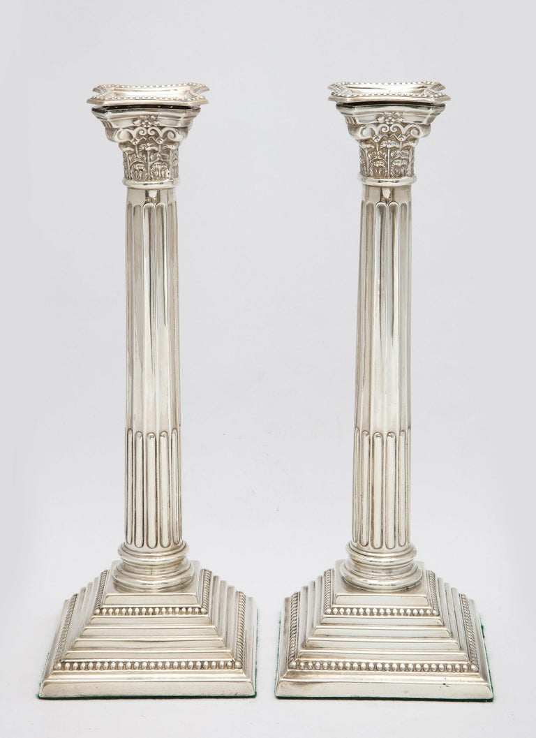 Pair of tall, Neoclassical-style, sterling silver Corinthian Column-form candlesticks, London, year-hallmarked for 1937, Britton, Gould and Co. - makers. Each candlestick measures 11 1/4 inches high x 4 inches deep (at deepest point) x 4 inches wide